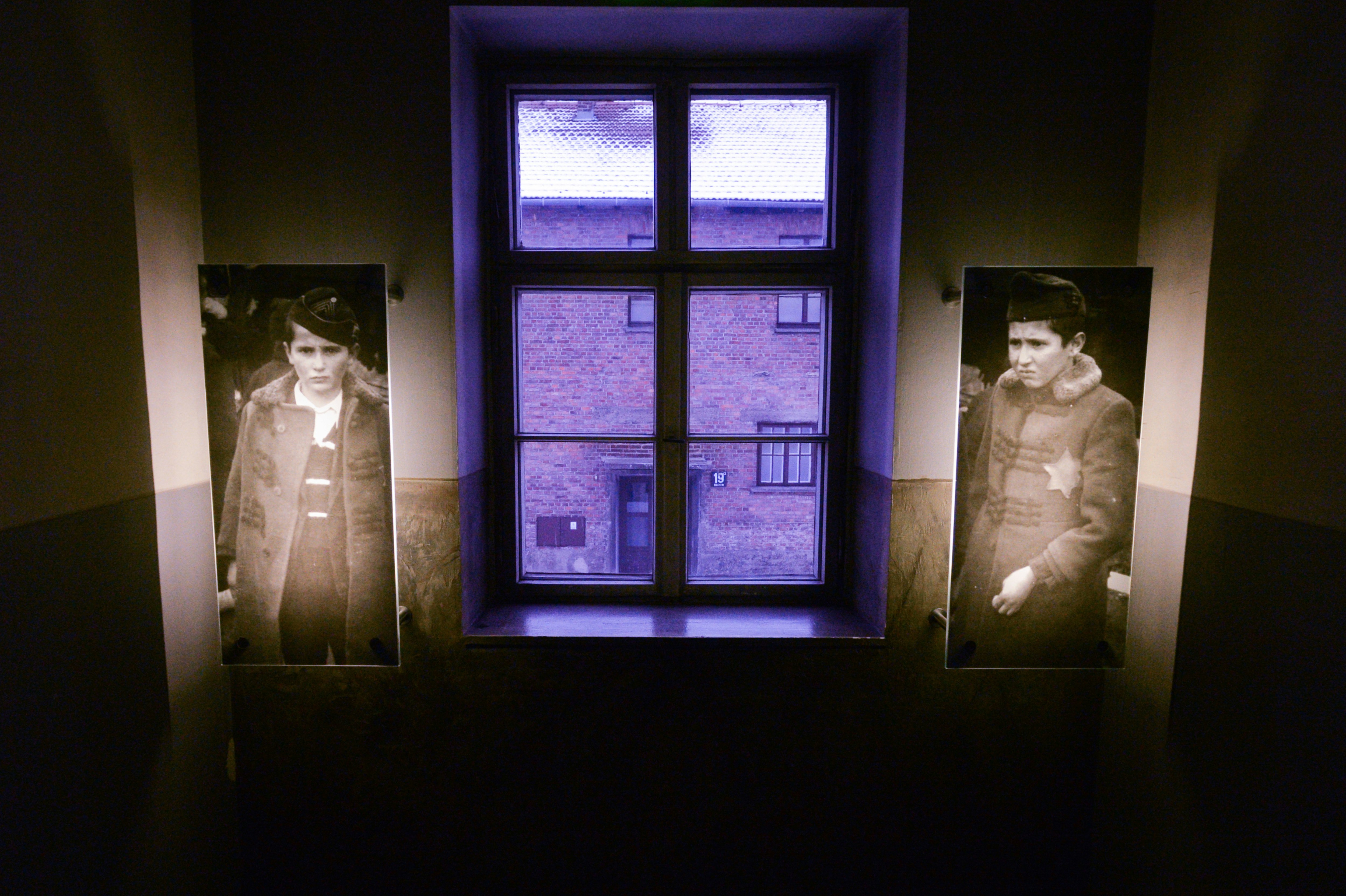 Two photos of young men hang in the holocaust museum 