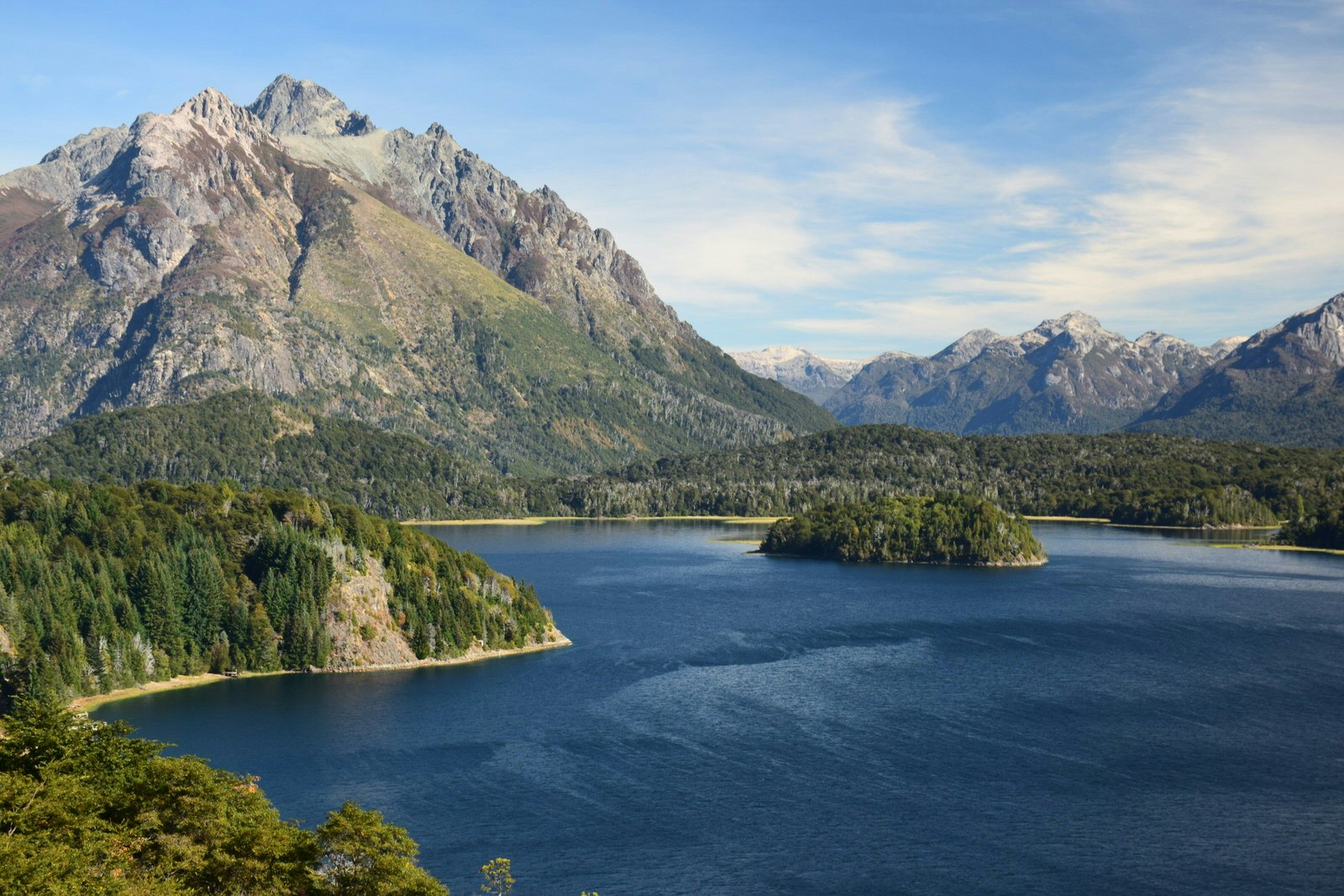 Rounded, treeless summits tower above the forests and lakes within Parque Nacional Nahuel Huapi.