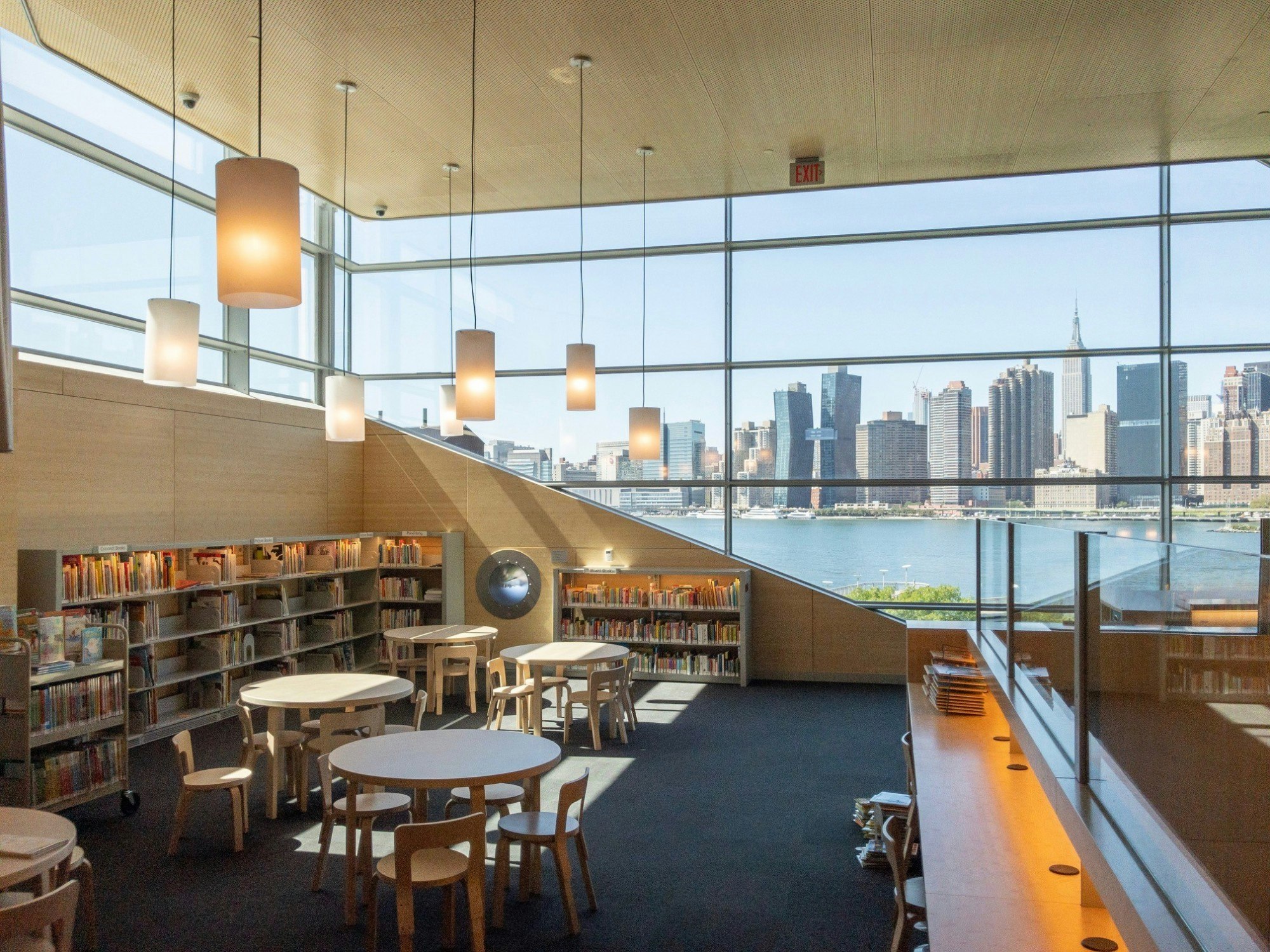 The interior of Hunters Point Community Library in New York complete with books and seating