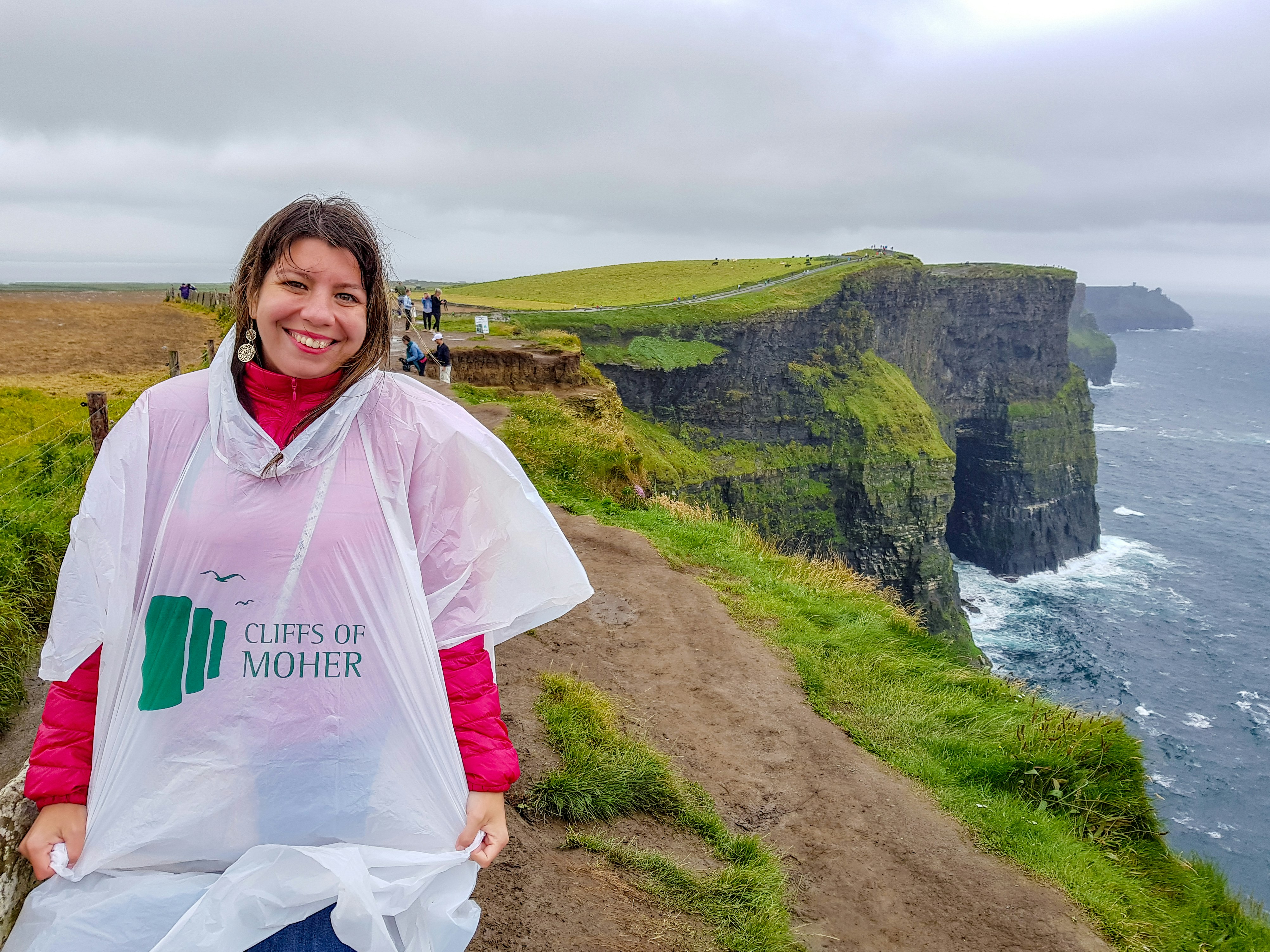 A woman in a rain poncho at the Cliffs of Moher