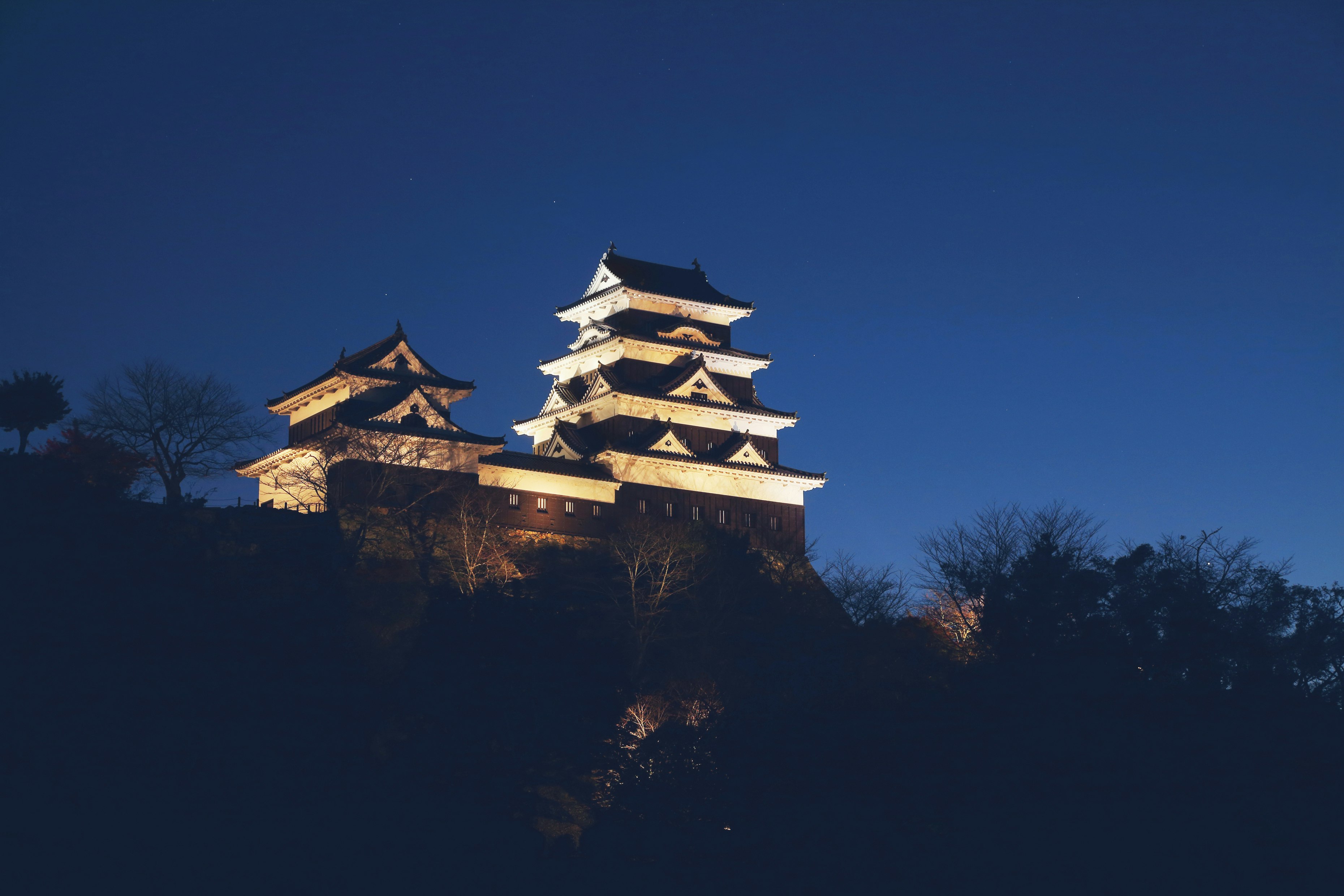 Exterior shot of Ozu Castle, Japan against a blue sky background
