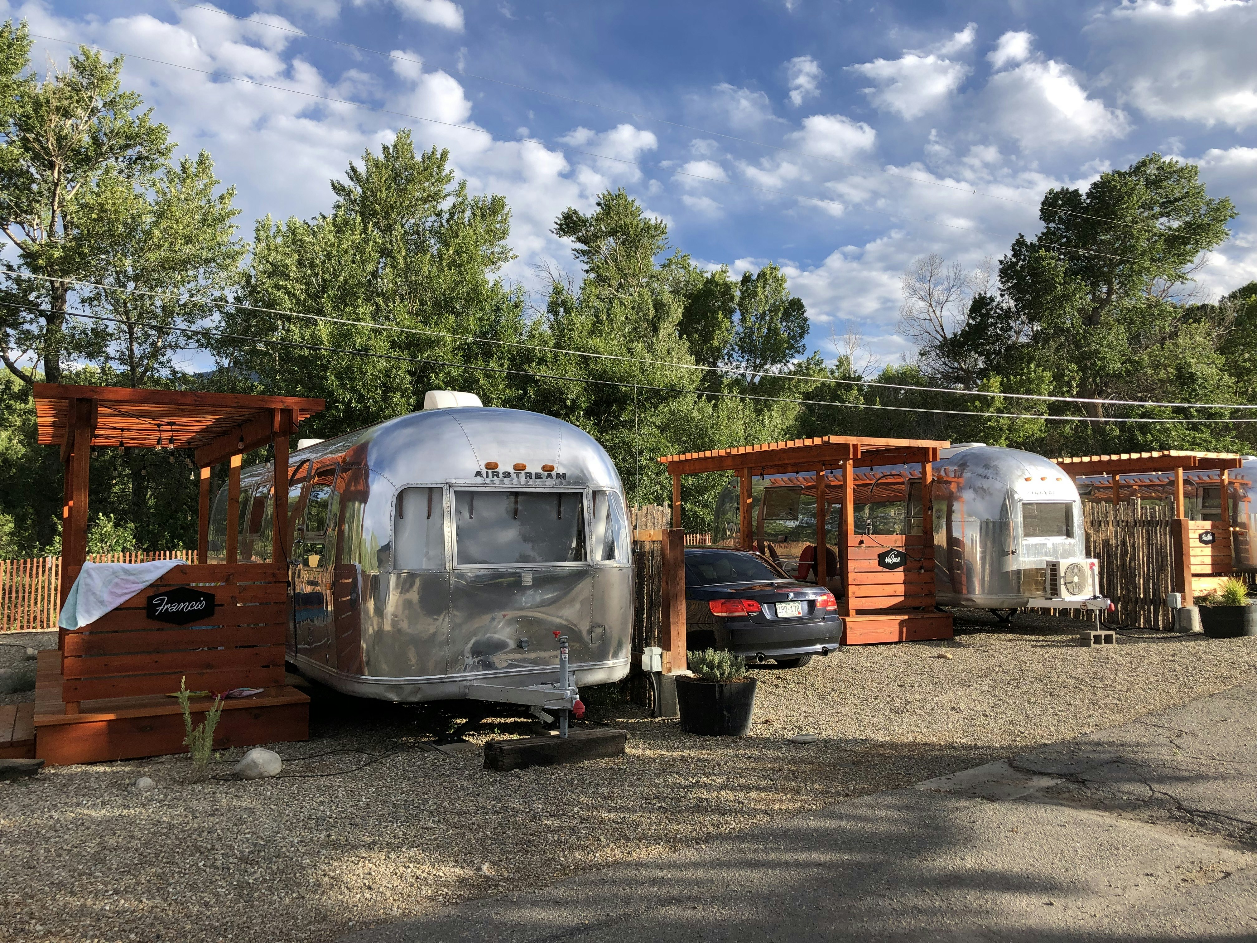 A line of airstream trailers with attached decks at the Amigo Motor Lodge