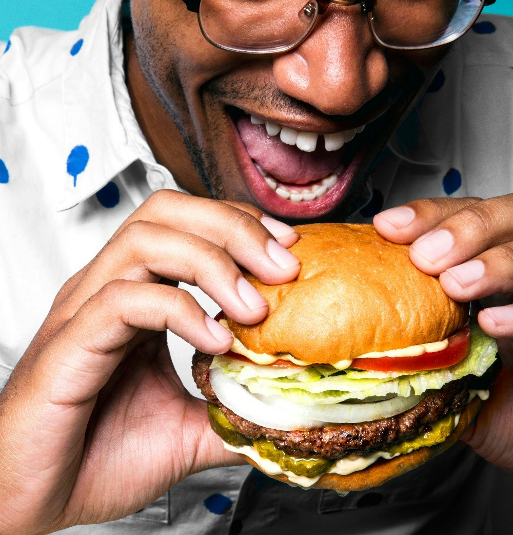 A black man eating a burger