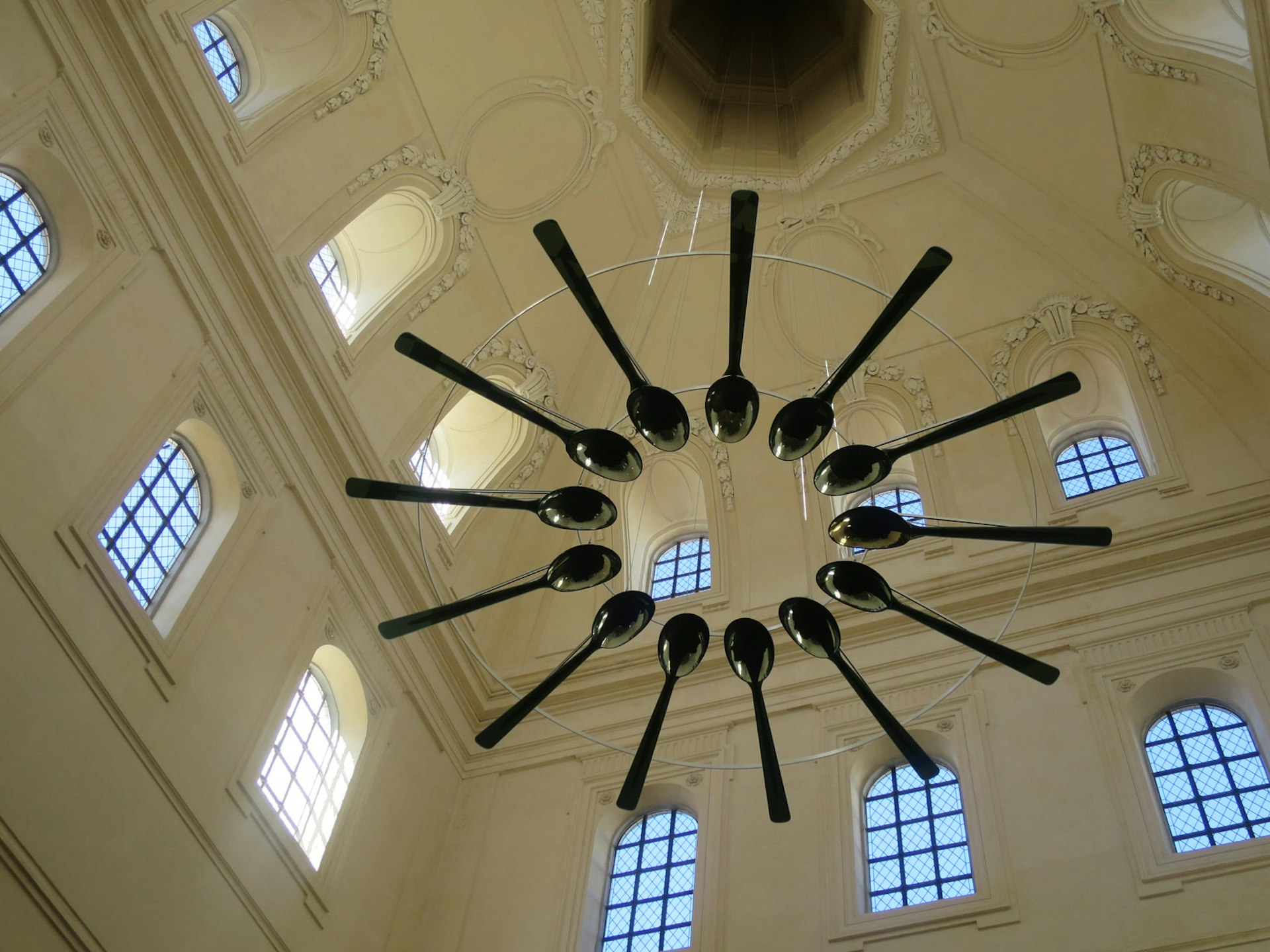 A wreath of over-sized spoons suspended from the ceiling at Lyon's Cité Internationale de la Gastronomie 