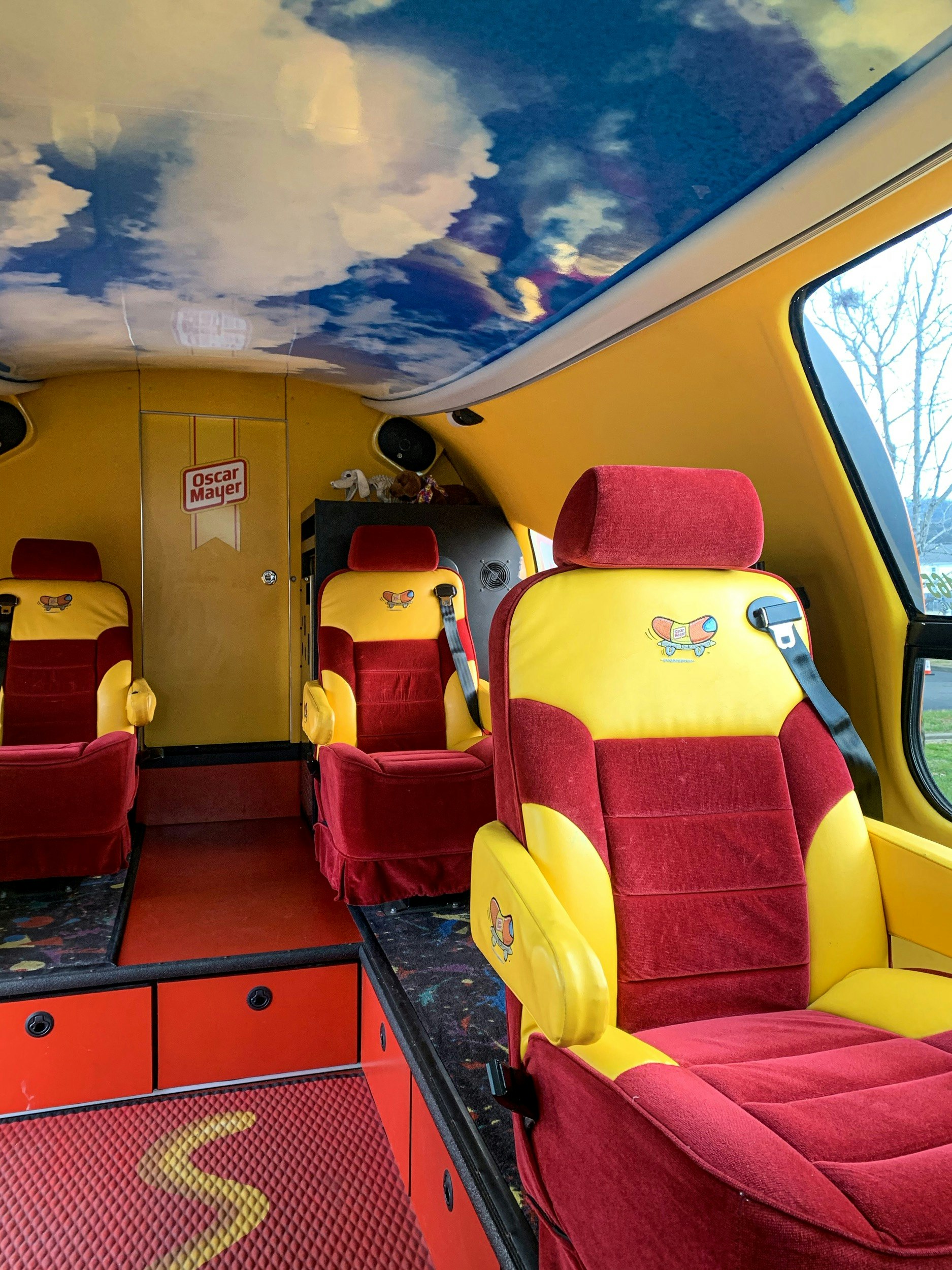 The inside of the Oscar Mayer Wienermobile has bright yellow and red upholstery