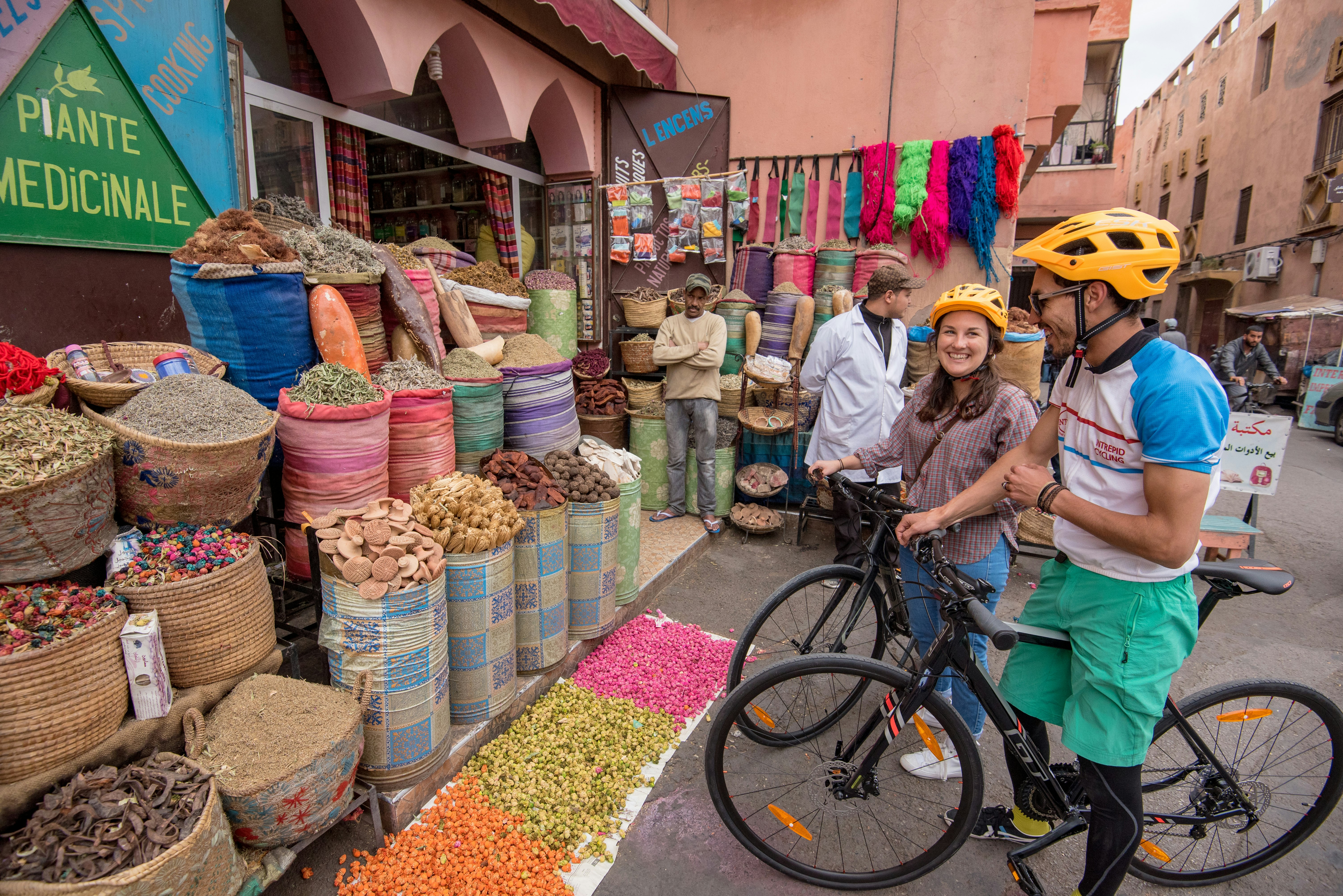 Family on bikes next to a colourful market stall.jpg