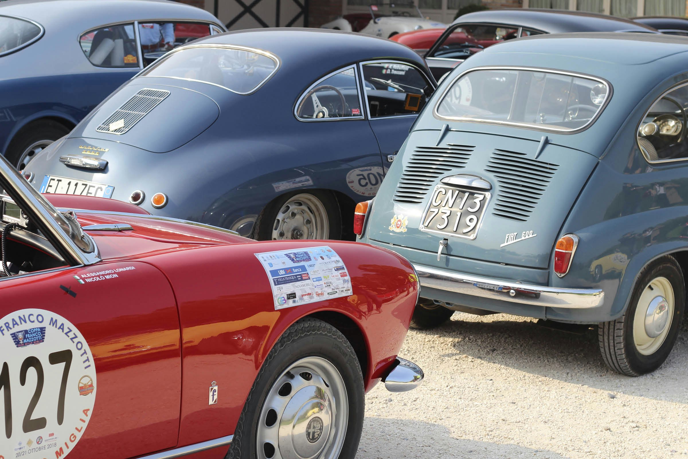 Blue and red classic cars parked at the Mille Miglia Museum