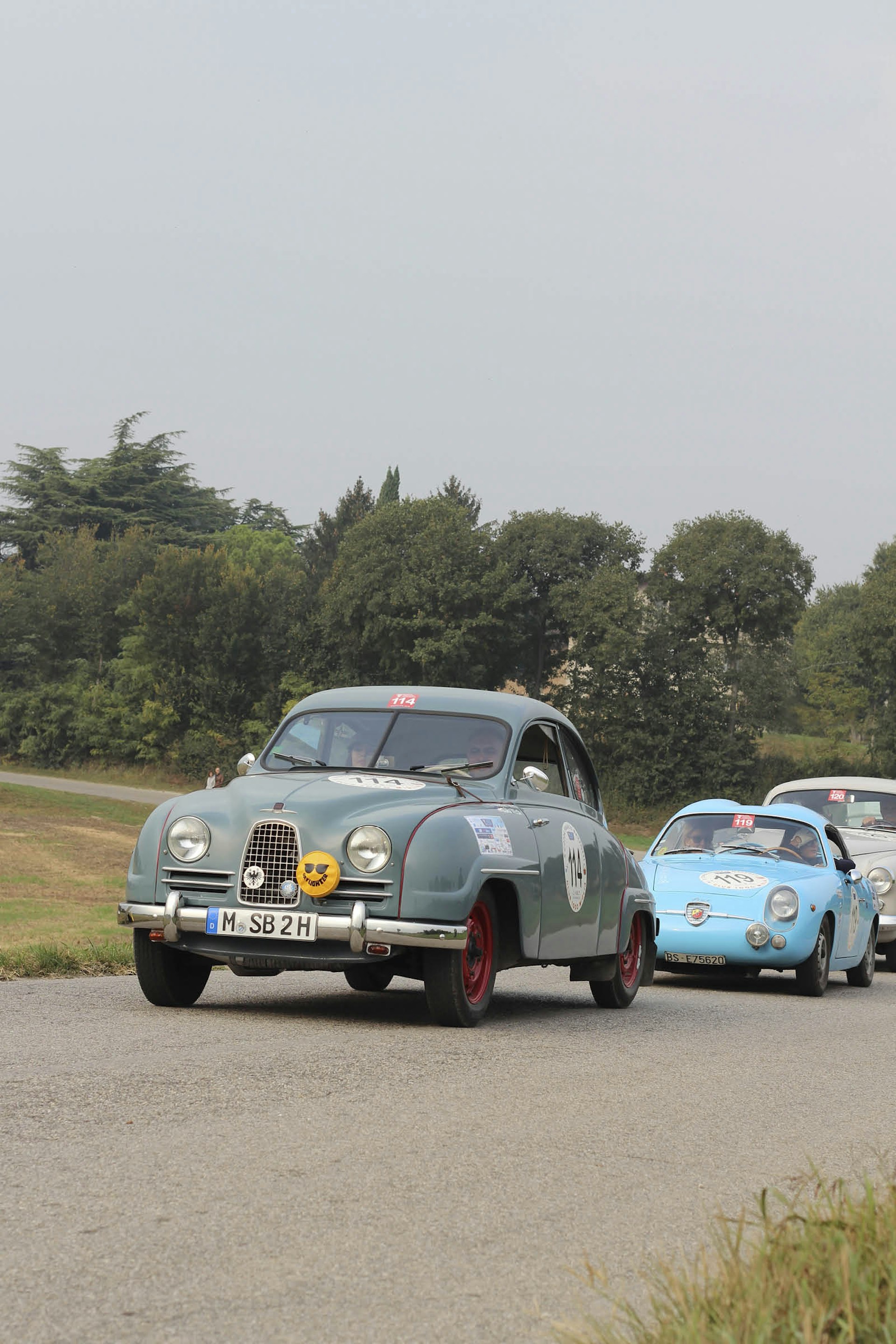 A German-registered Saab 93A leads a trio of cars