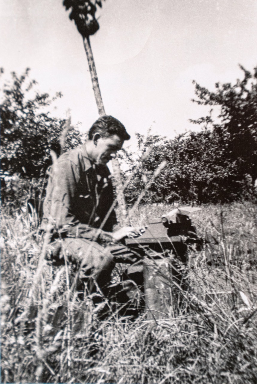 J.D. Salinger with typewriter in a field in Normandy, France, 1944
