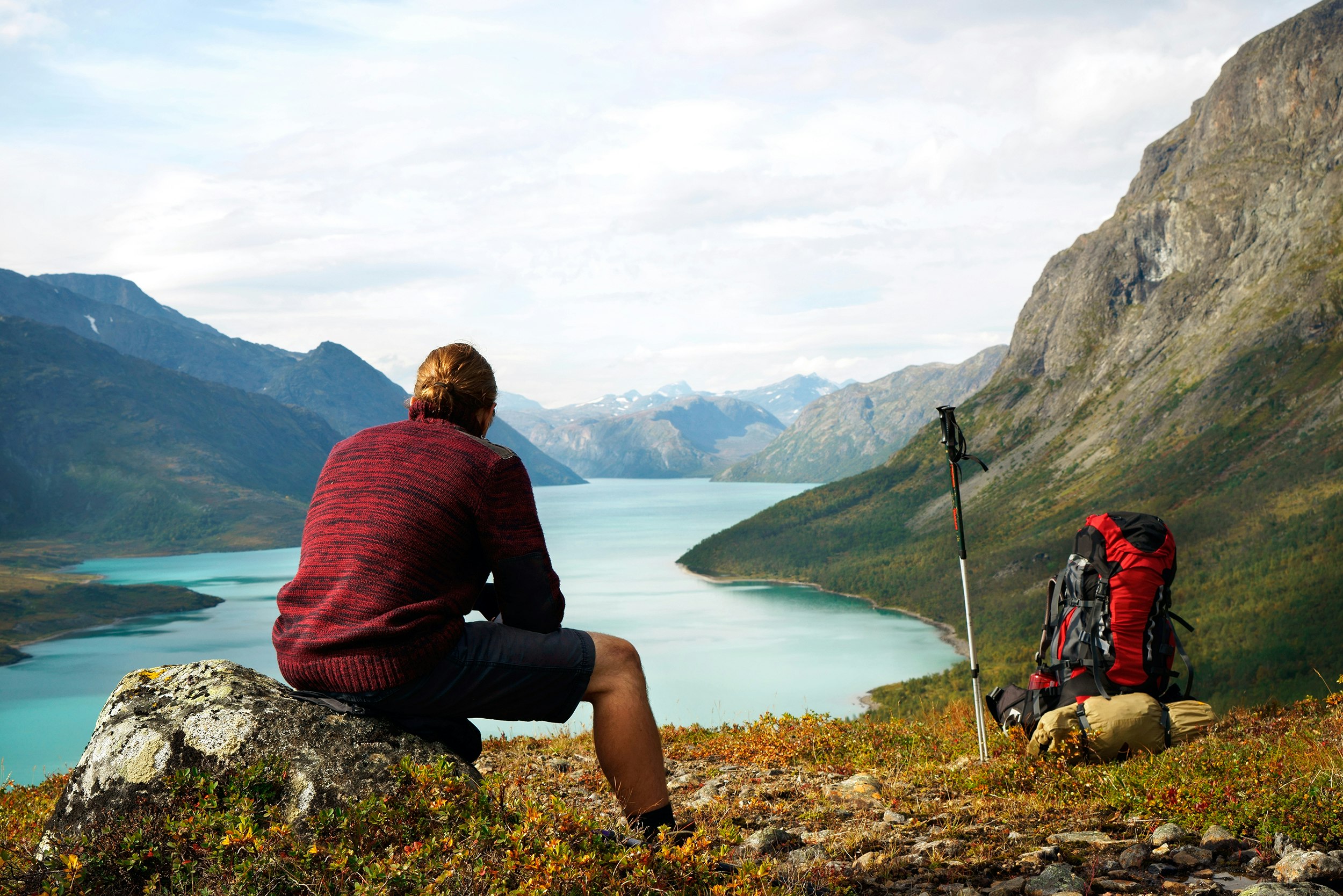 A hiker on the edge of a fjord 