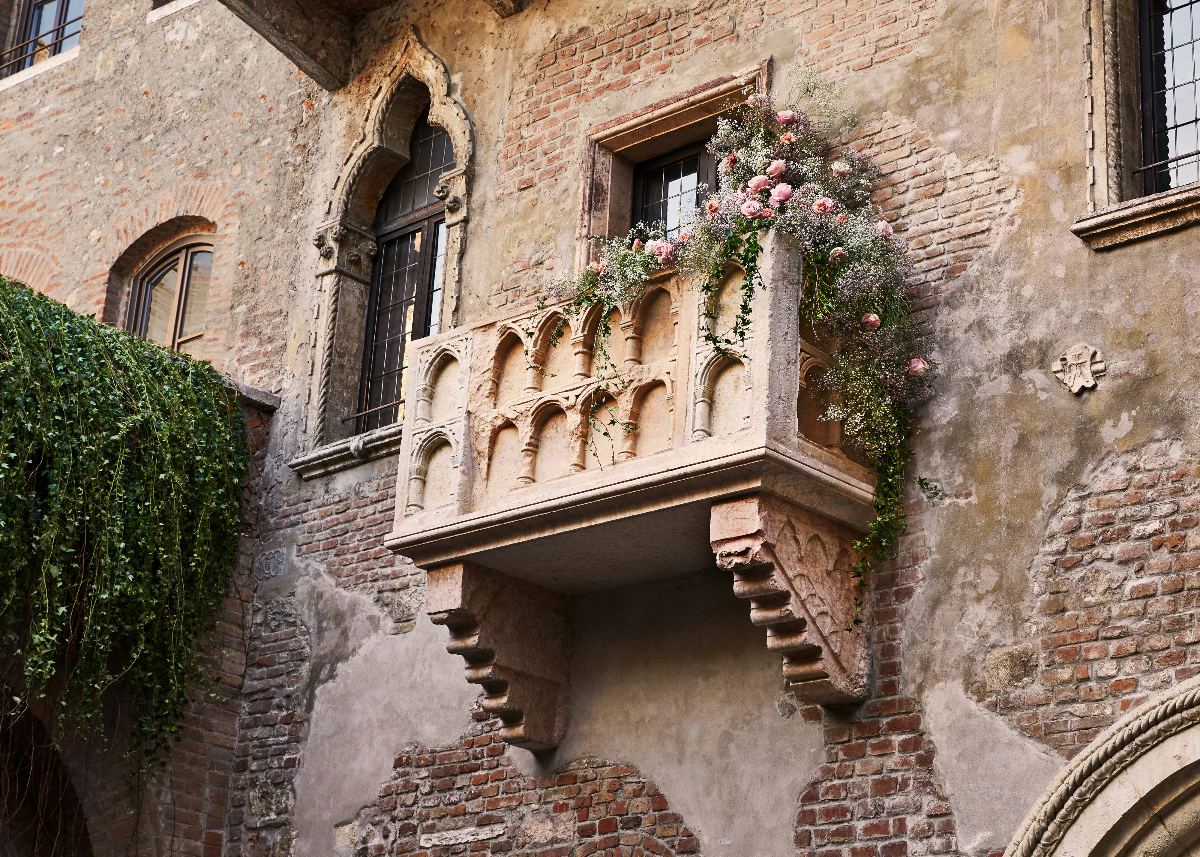 The 13th-century balcony, draped with vines and flowers, associated with Juliet's "wherefore art thou Romeo" speech