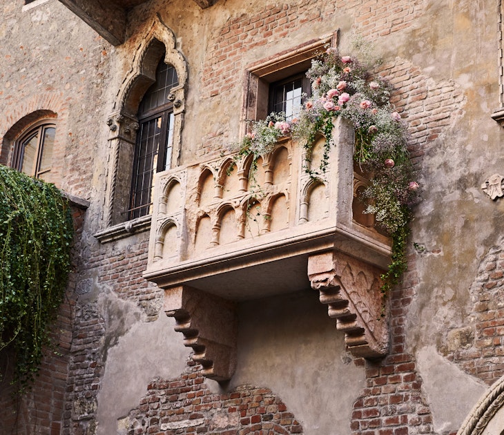 The 13th-century balcony, draped with vines and flowers, associated with Juliet's "wherefore art thou Romeo" speech