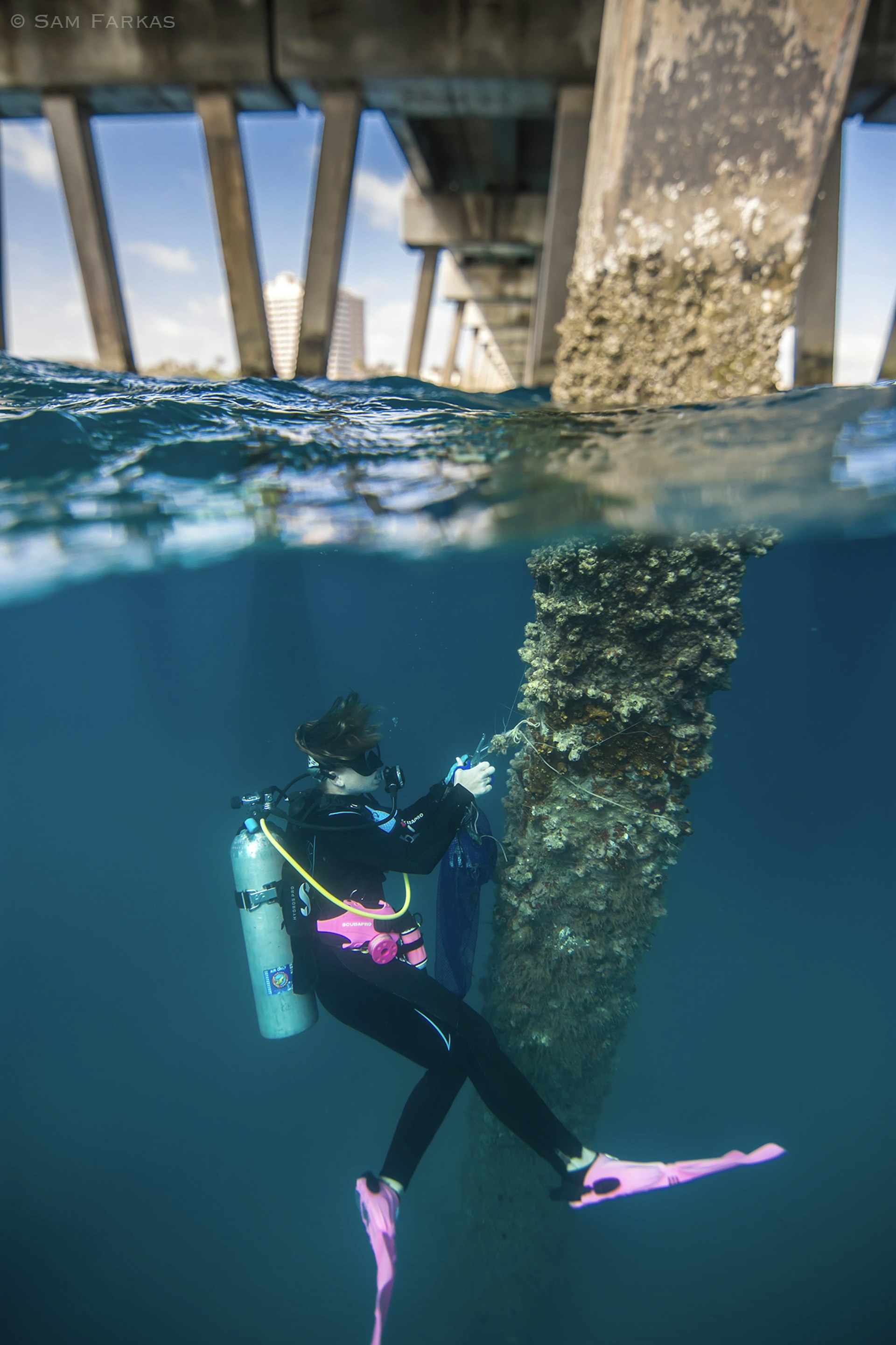 Katie O'Hara cleans the underwater pier 