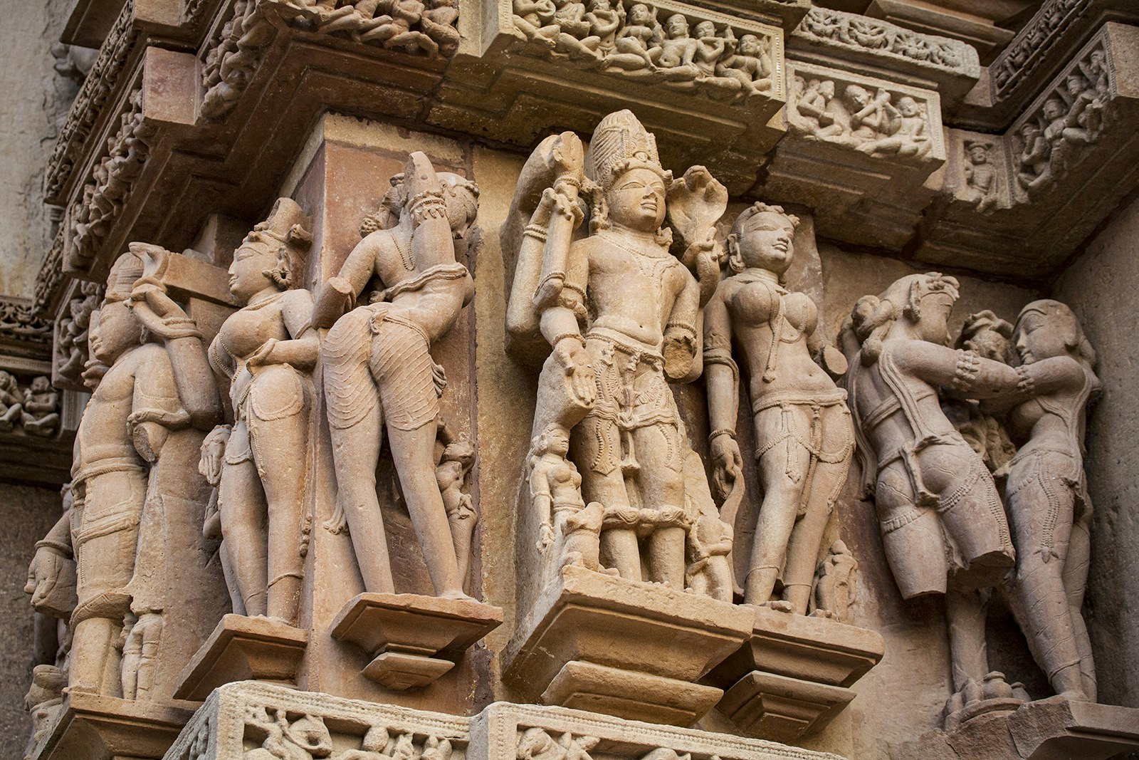 Scantily clad sandstone sculptures cover the walls of the Lakshmana temple. Madhya Pradesh, India.
