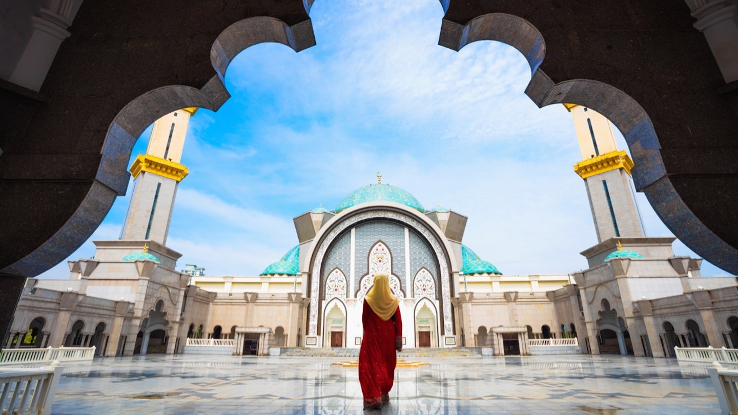 A woman enters the Federal Territory Mosque in Kuala Lumpur
