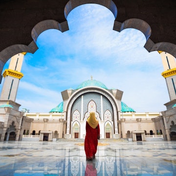 A woman enters the Federal Territory Mosque in Kuala Lumpur