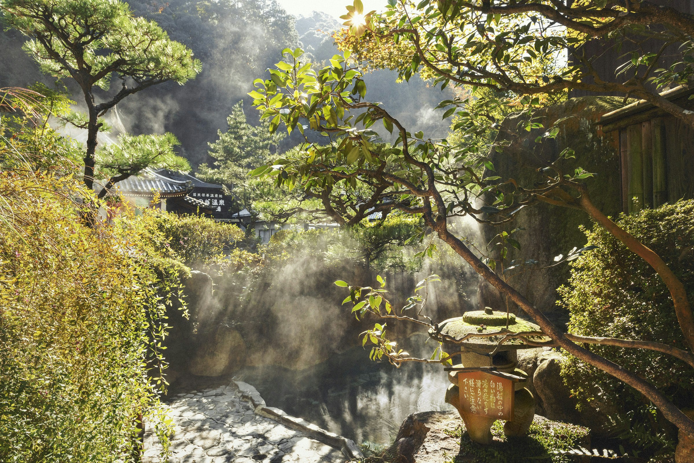 Steam rises from an outdoor hot spring bath in Yunomine