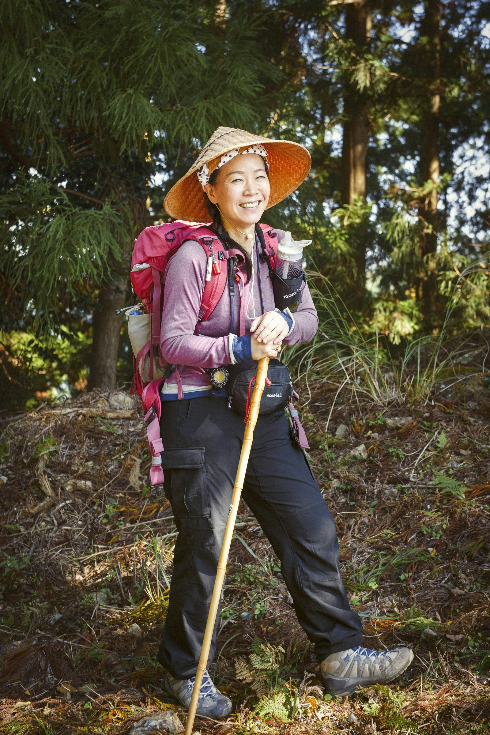 Trail guide Kennis Wong wears a traditional pilgrim's conical hat