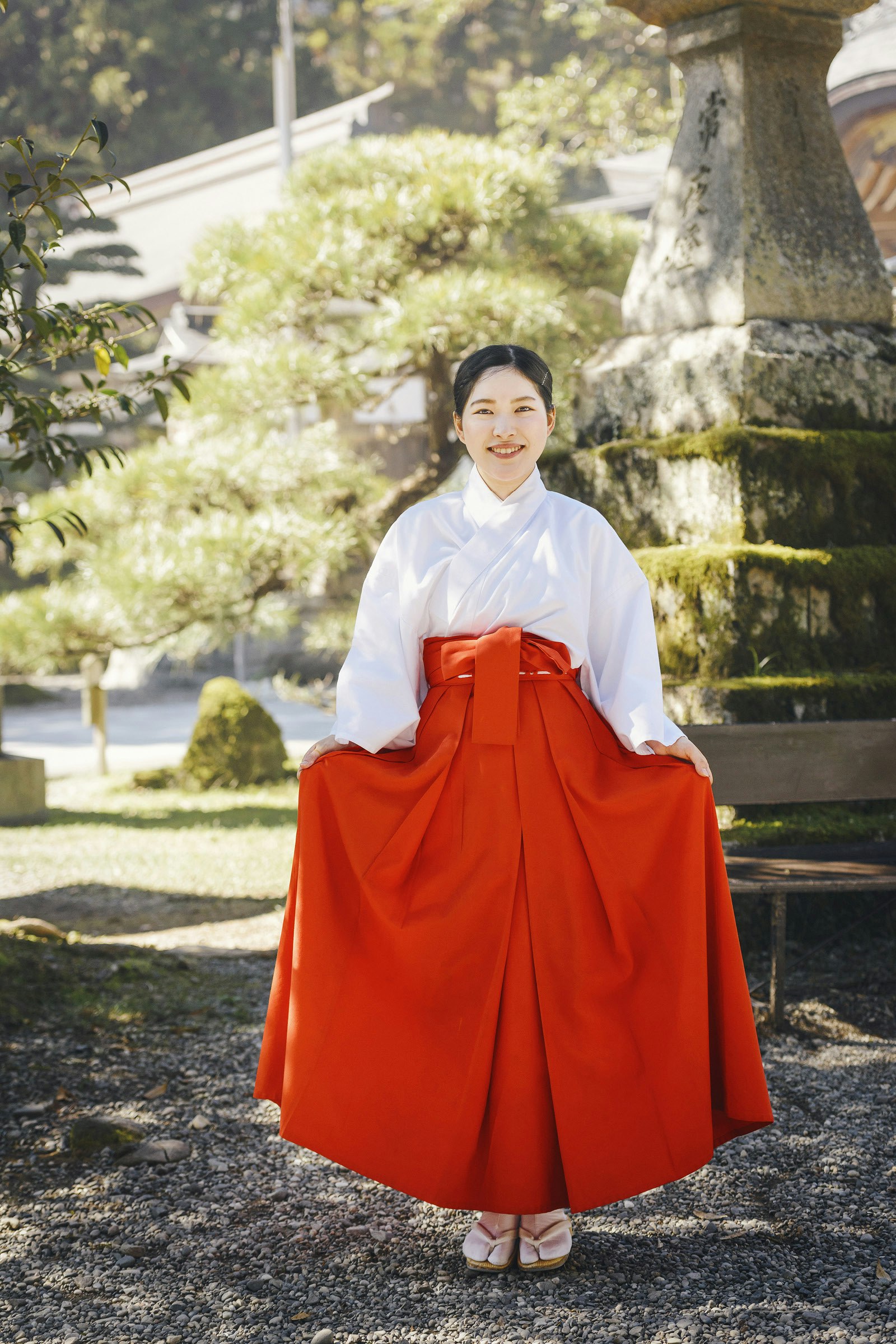 Ami Ozaki in the white-and-red costume of a shrine maiden
