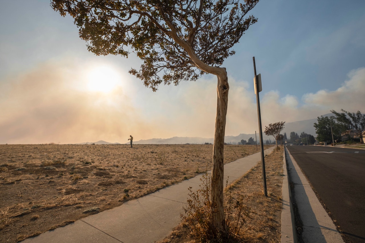 Smoke from the Saddleridge Fire in San Fernando Valley, seen floating on the horizon in Los Angeles's Porter Ranch neighborhood on Friday, Oct. 11