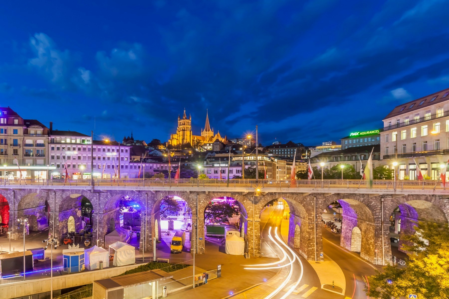 Vibrant colours light up the archways under the Grand Pont Bridge in Lausanne at night