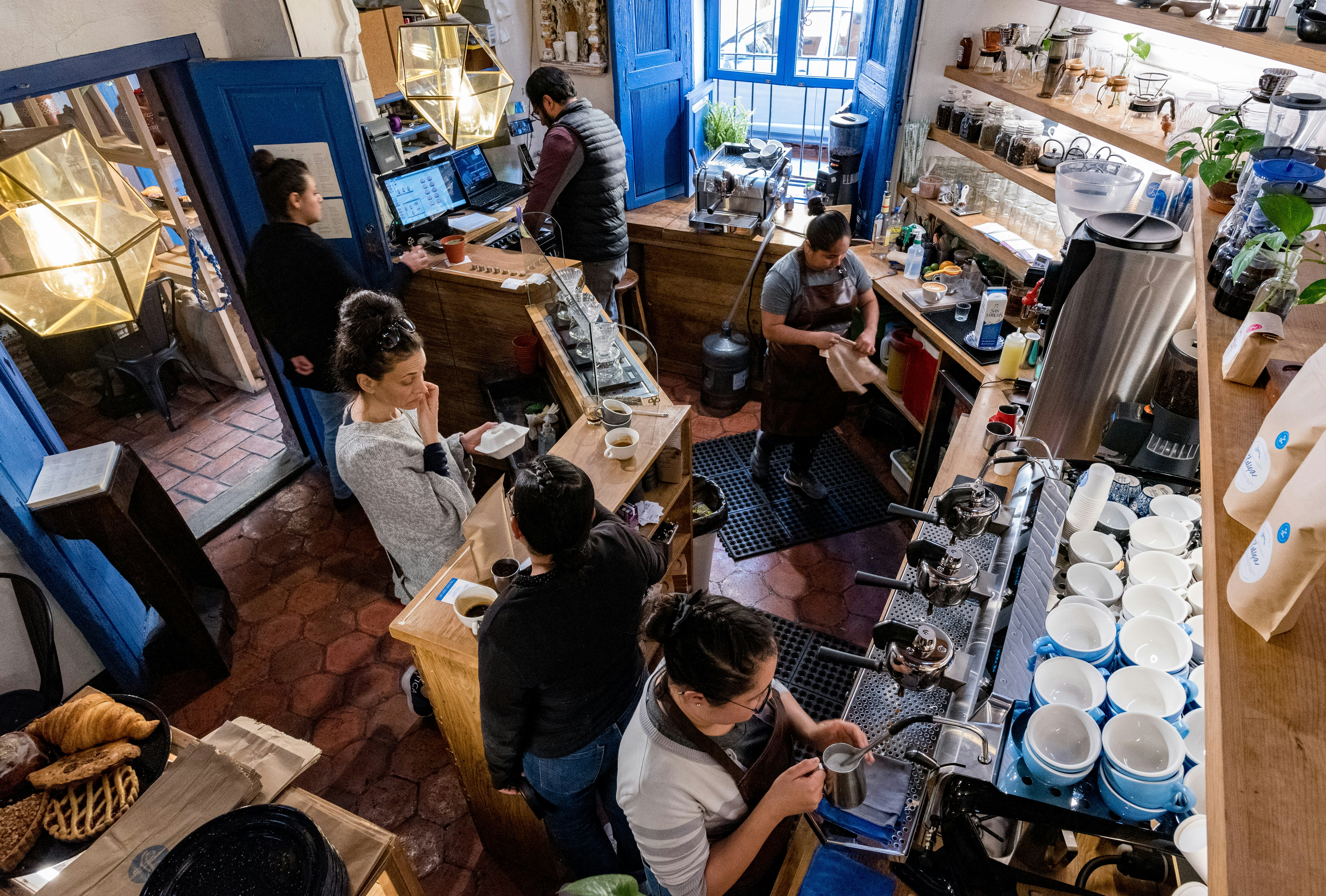 A bird's-eye view of baristas preparing coffee in Lavanda Cafe, San Miguel de Allende