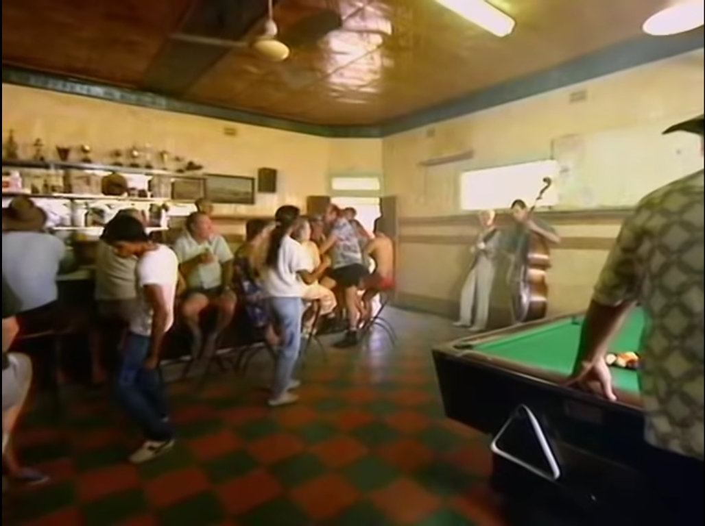 A still of people dancing in a bar from David Bowie's Let's Dance video