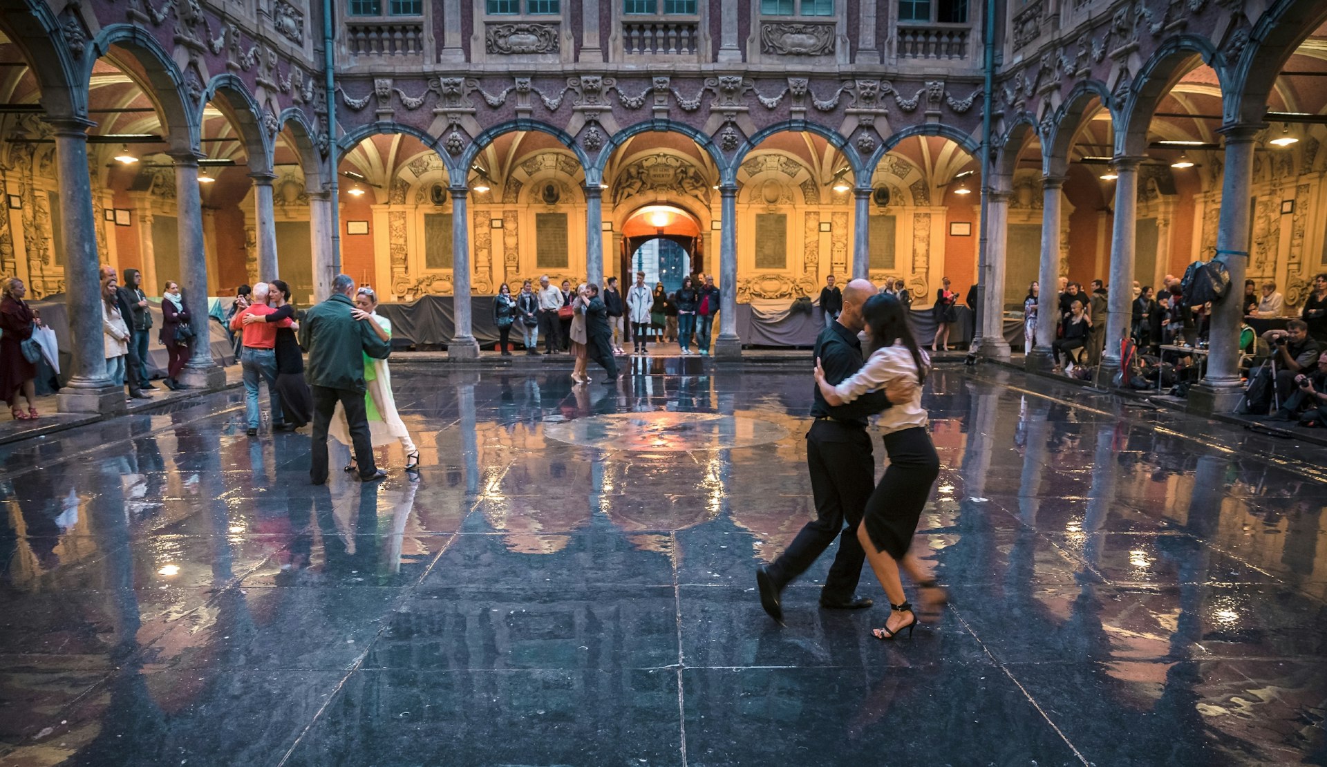 Couples dancing inside La Vieille Bourse, an ornate 17th-century Renaissance stock exchange.
