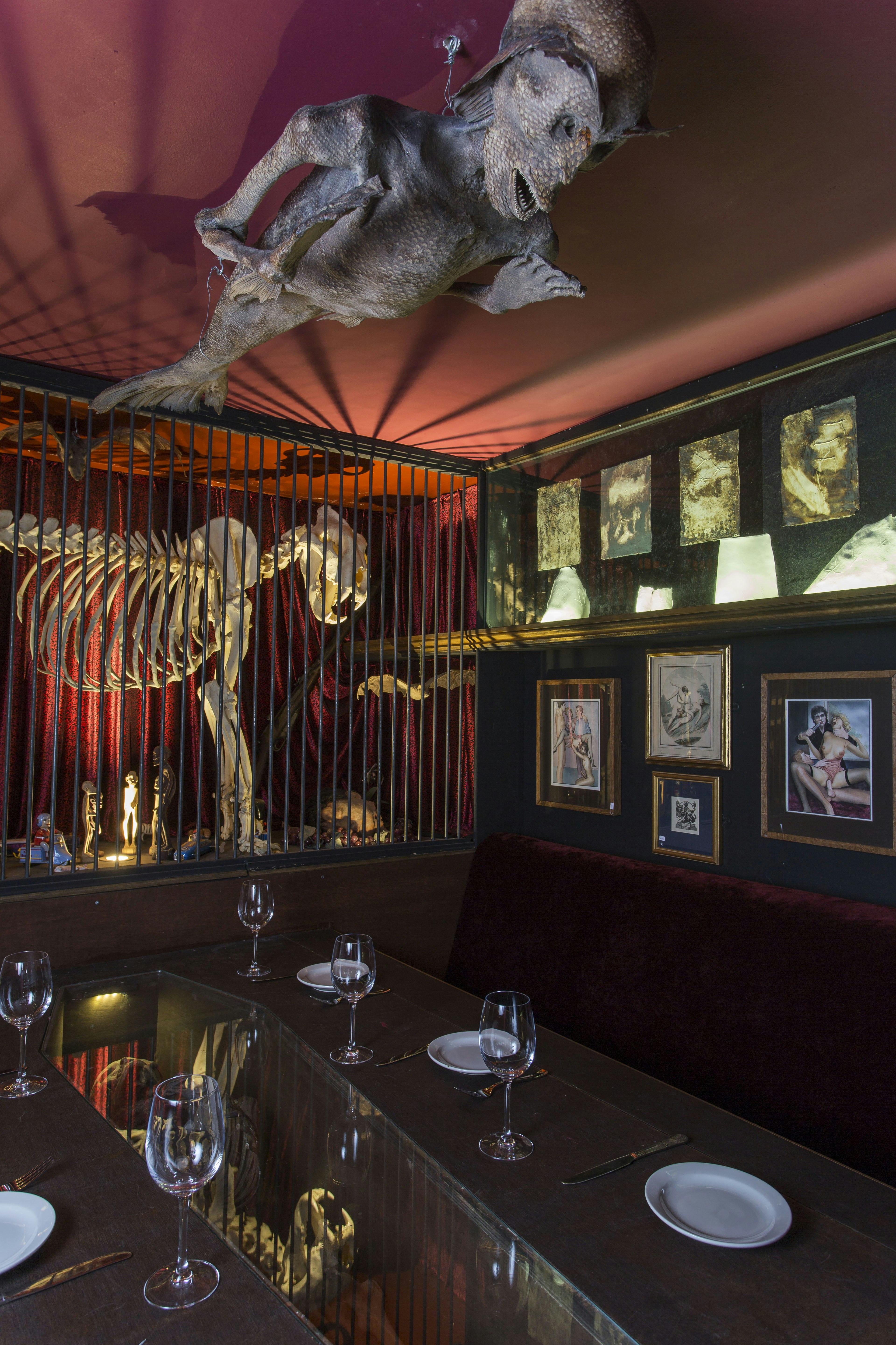A lion skeleton in a cage and a sea monster model hanging from the ceiling of the Last Tuesday Society bar in east London.