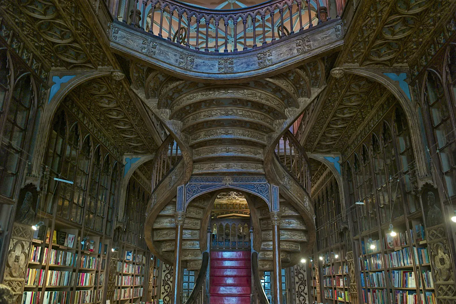 Livraria Lello.jpg Ornate book shelves and a elegantly carved stair case in a book store in Portugal