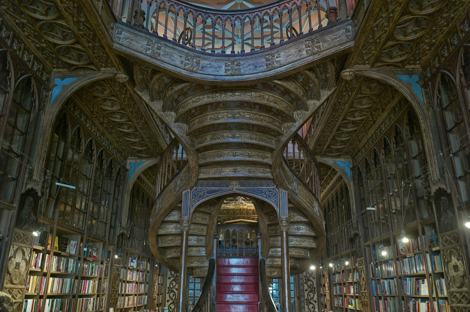 Ornate book shelves and a elegantly carved stair case in a book store in Portugal