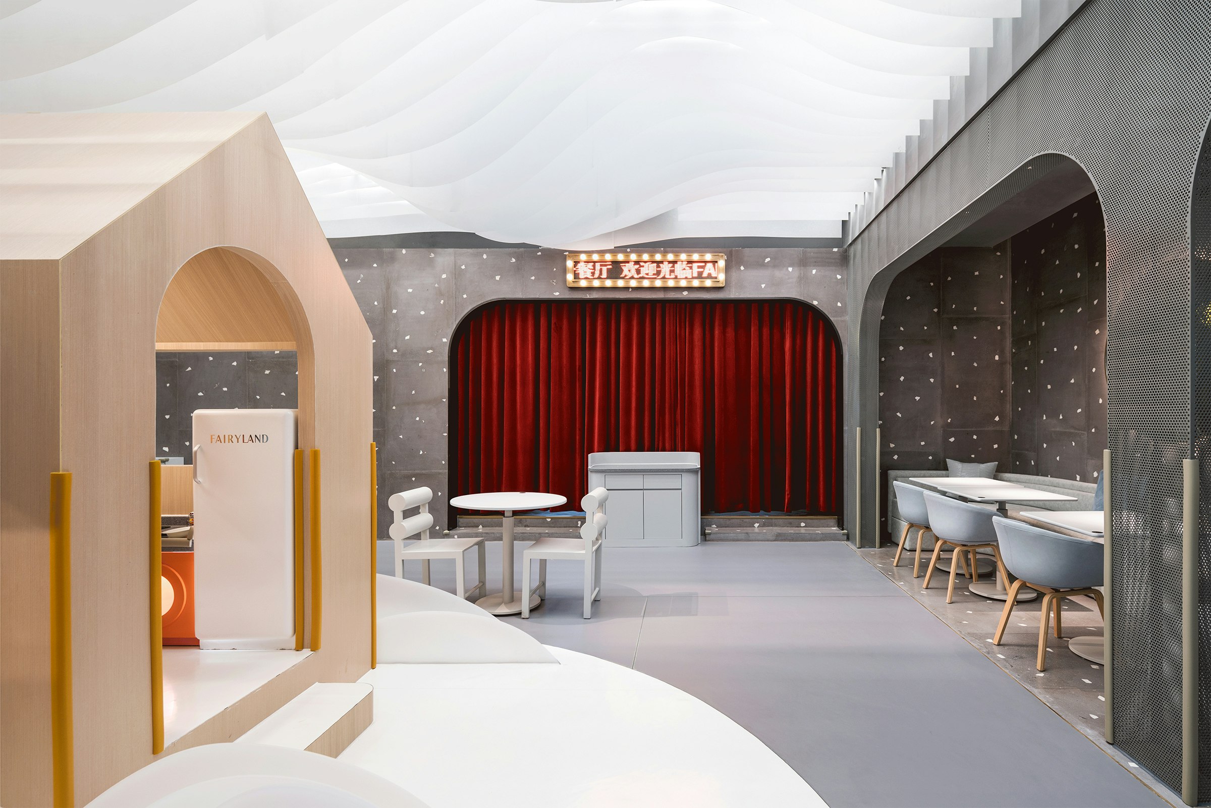 Playful white and grey children's cafe with a deep red curtain