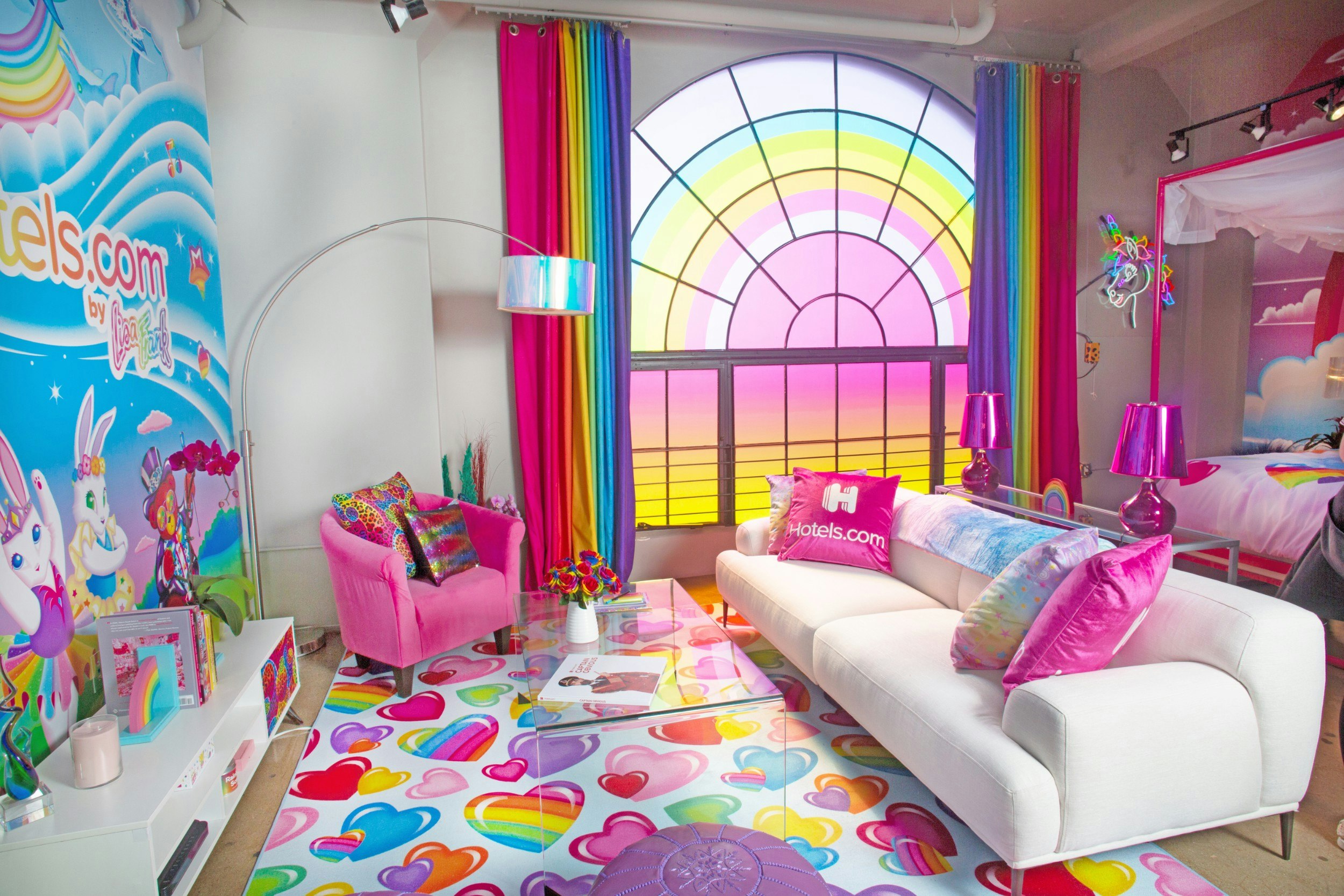 The colourful lounge complete with white sofa and rainbow window mural