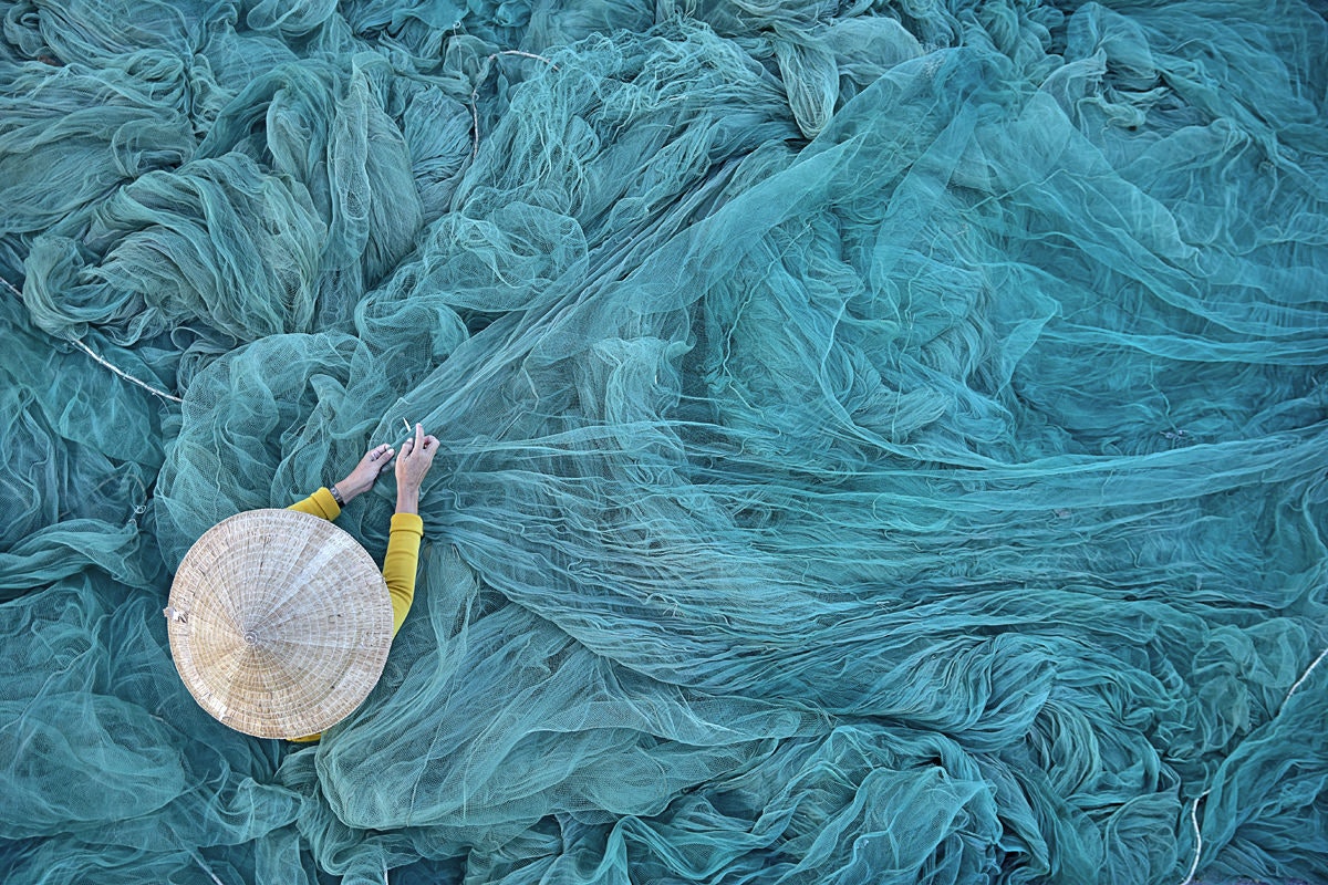A person fixing nets in Vietnam