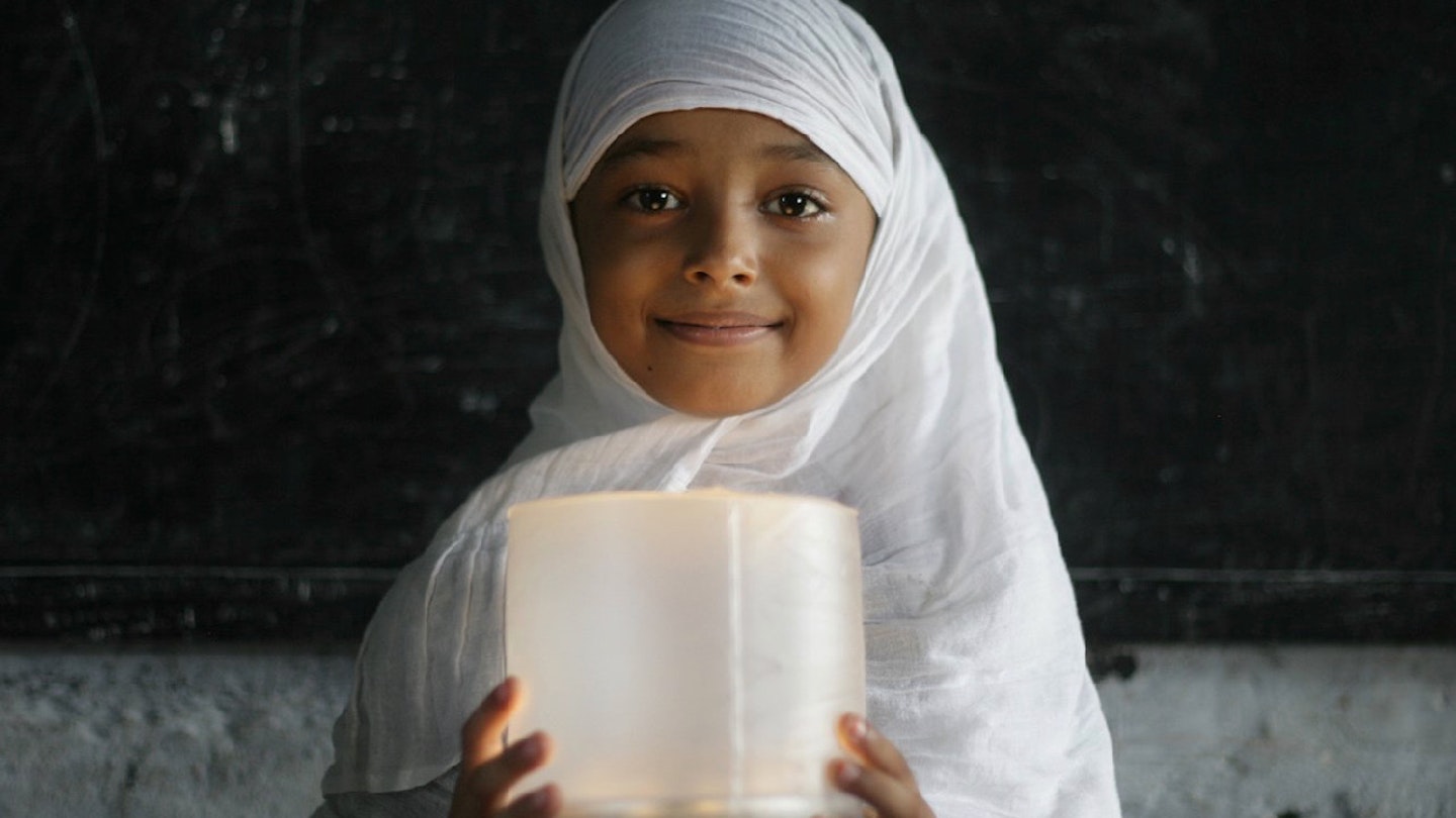 Girl holding an MPOWERD Luci light