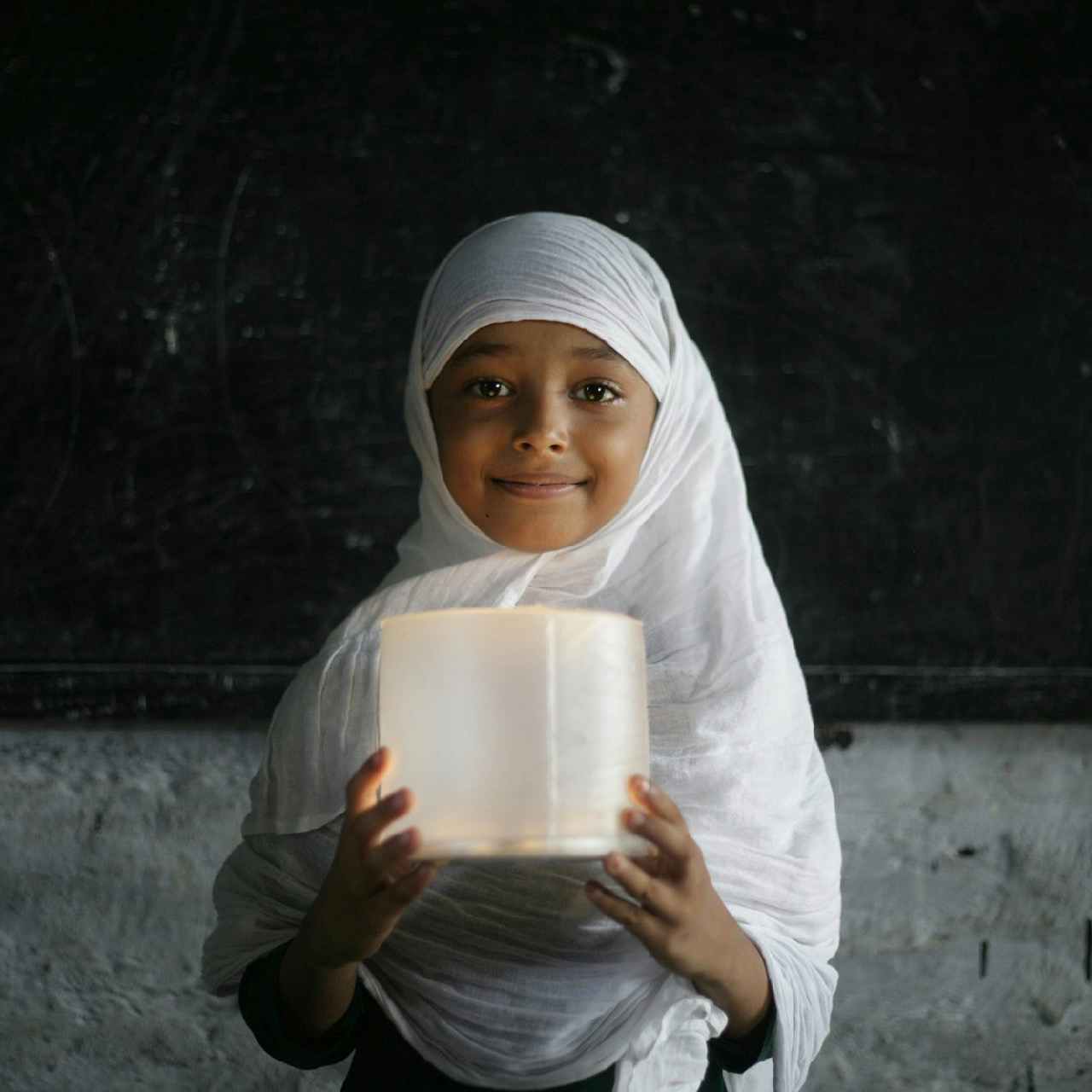 Girl holding an MPOWERD Luci light