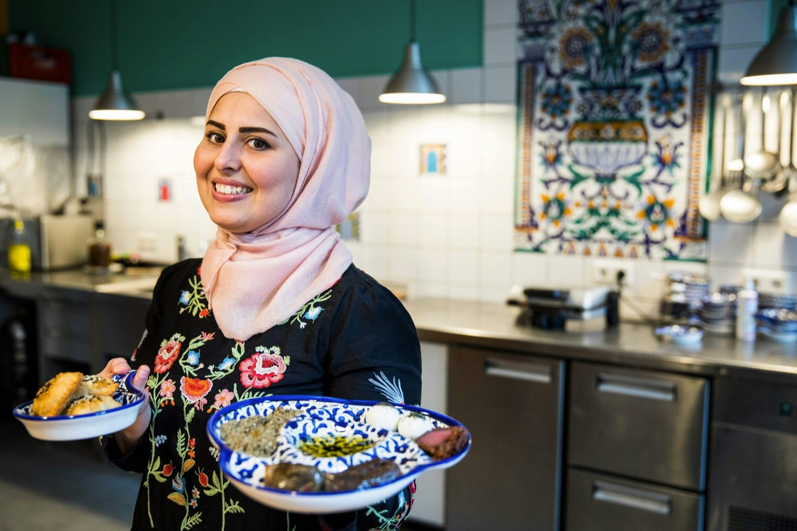 Malakeh Jazmati presents a signature dish in her kitchen