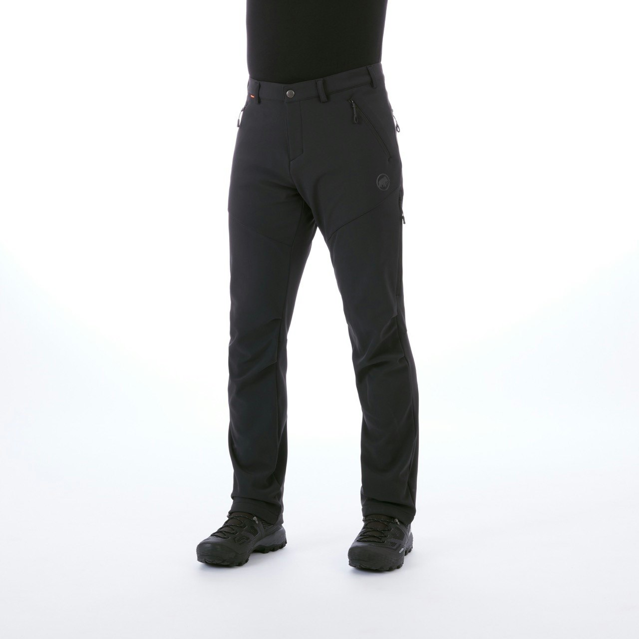 a man's torso wearing a black shirt, black Mammut winter hiking pants, and black boots