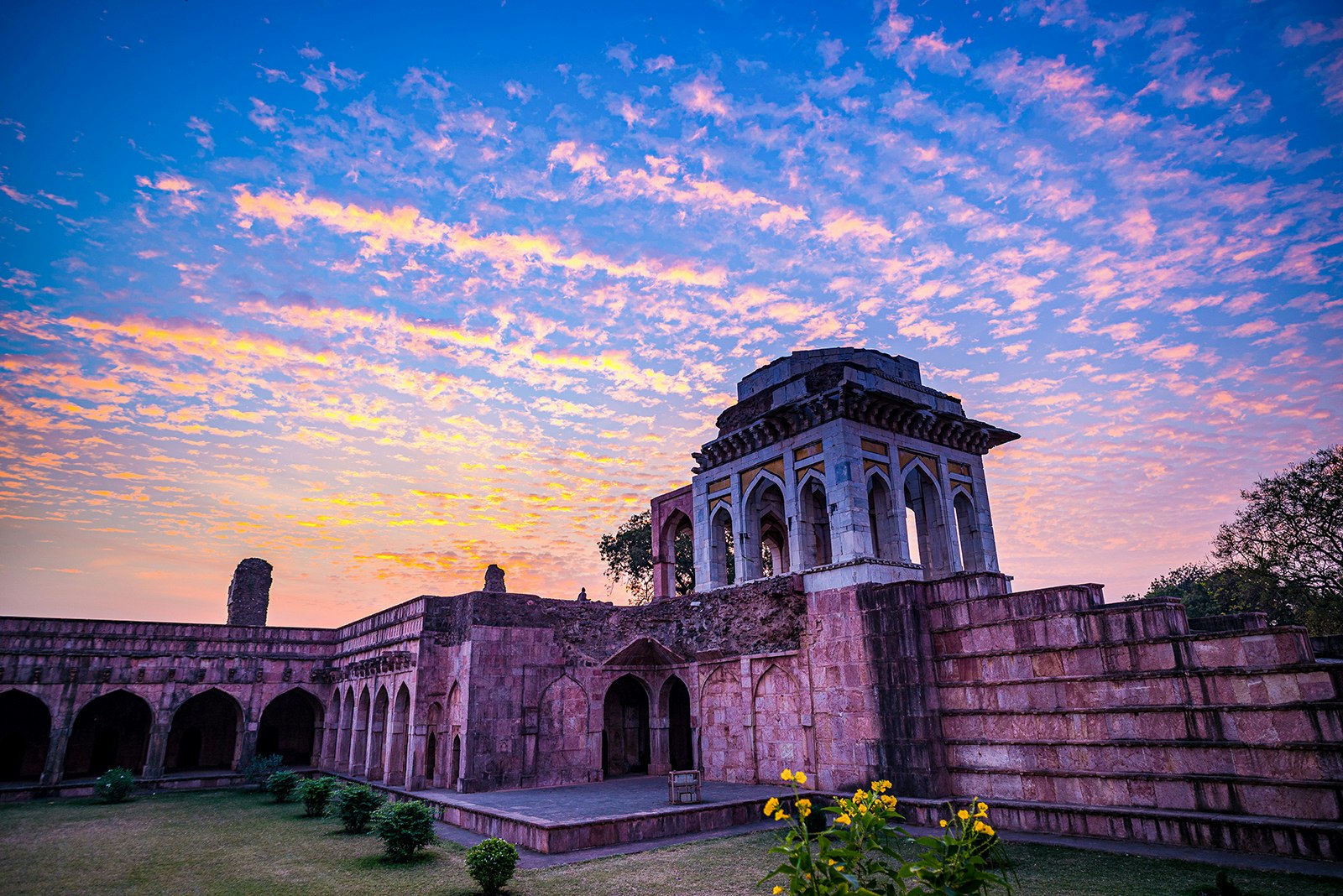 The Afghan ruins at Mandu, backlit by blue, pink and orange at sunrise. Madhya Pradesh, India.