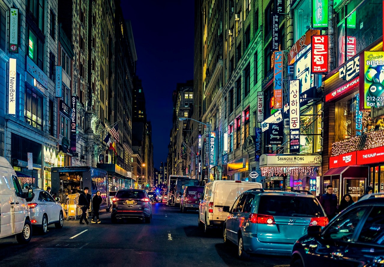 Manhattan's 32nd Street in Koreatown, the center of the thriving Korean business and entertainment community and district, at night with cars and bright lights