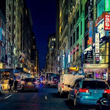 Manhattan's 32nd Street in Koreatown, the center of the thriving Korean business and entertainment community and district, at night with cars and bright lights