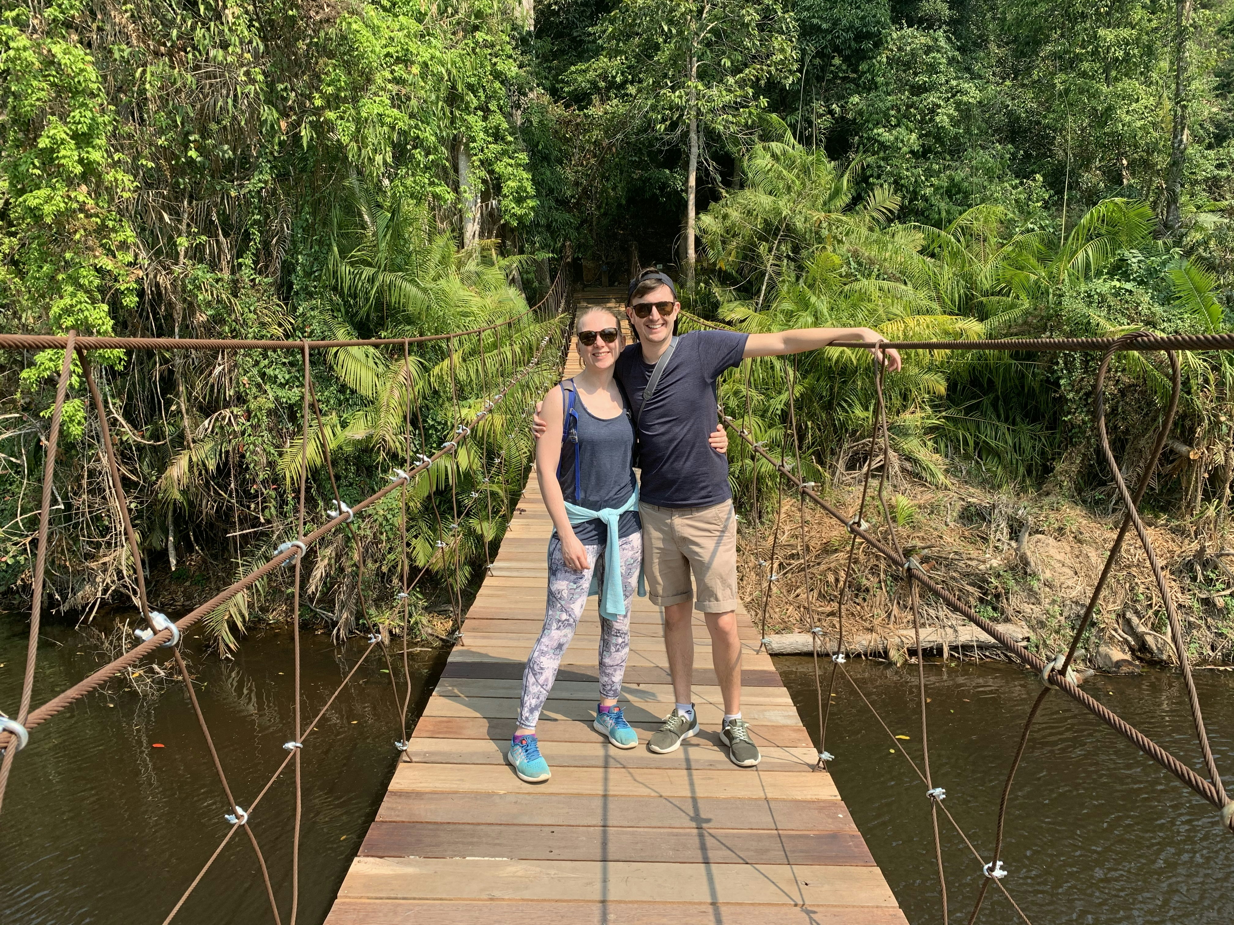 Couple Mark Burton and Frankie Lewis stand on a bridge whilst travelling in Asia.