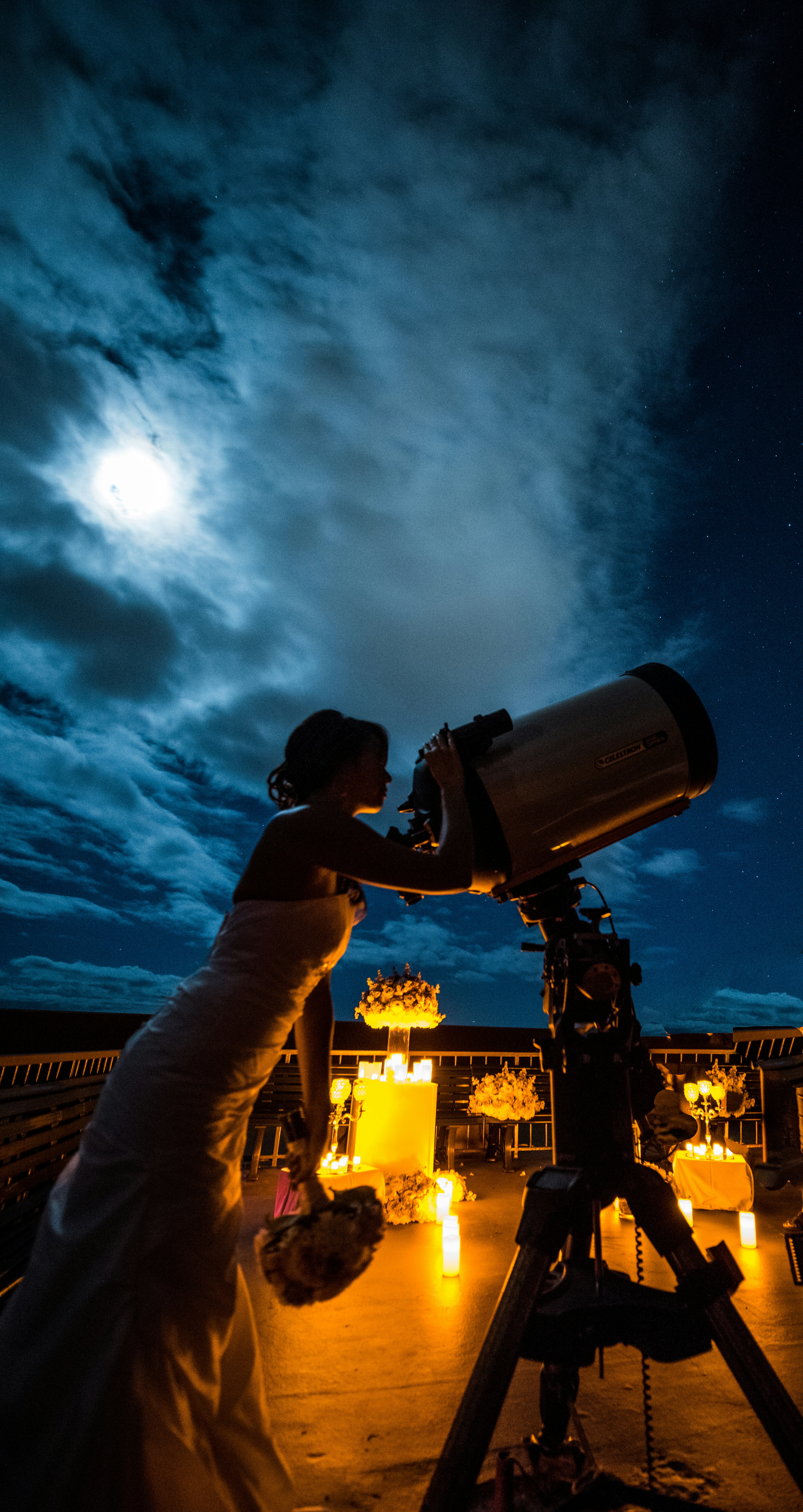 Bride looking at the stars through a telescope.jpg