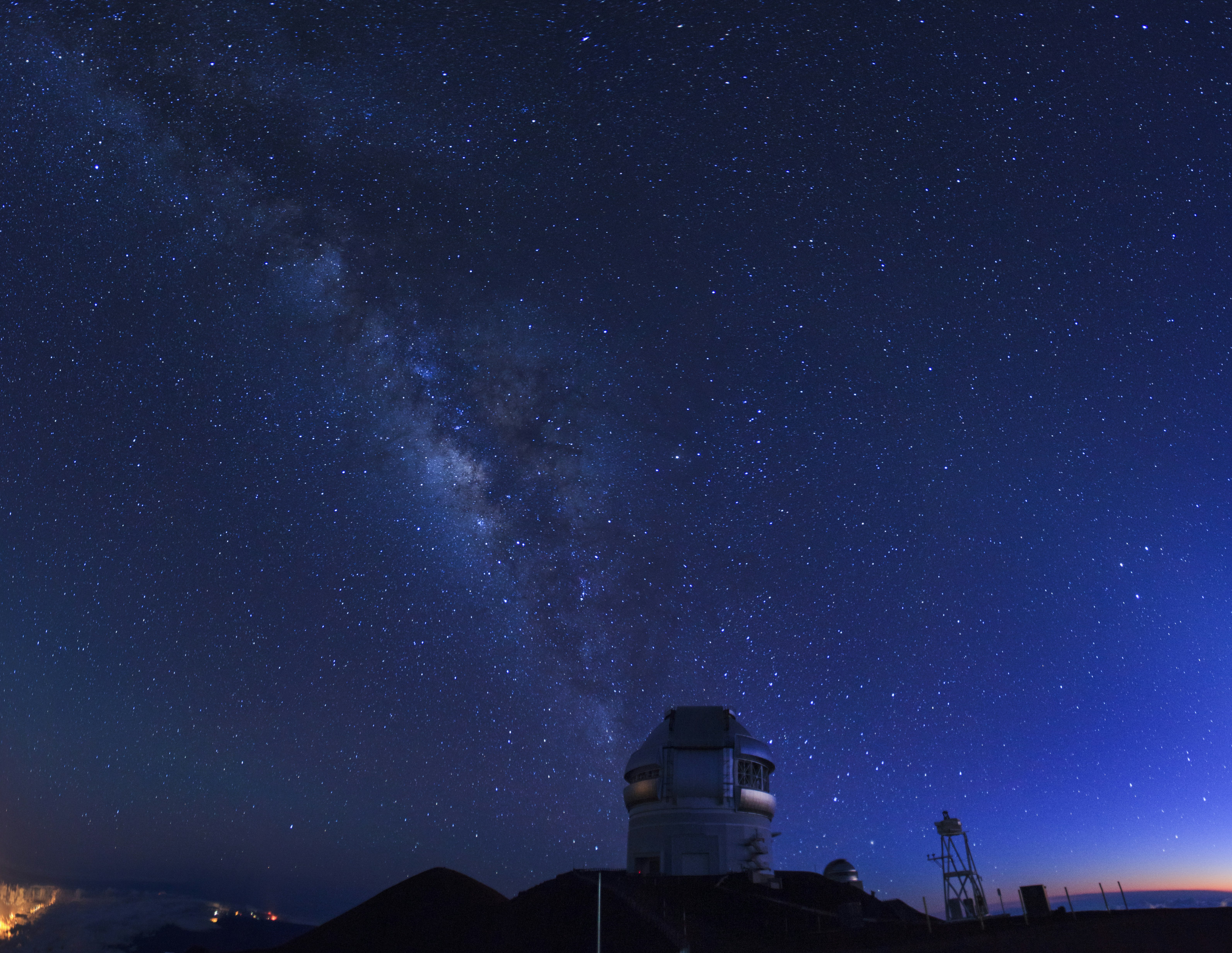 Brilliant stars shine above an observatory on Mauna Kea in Hawaii; Big Island Experiences
