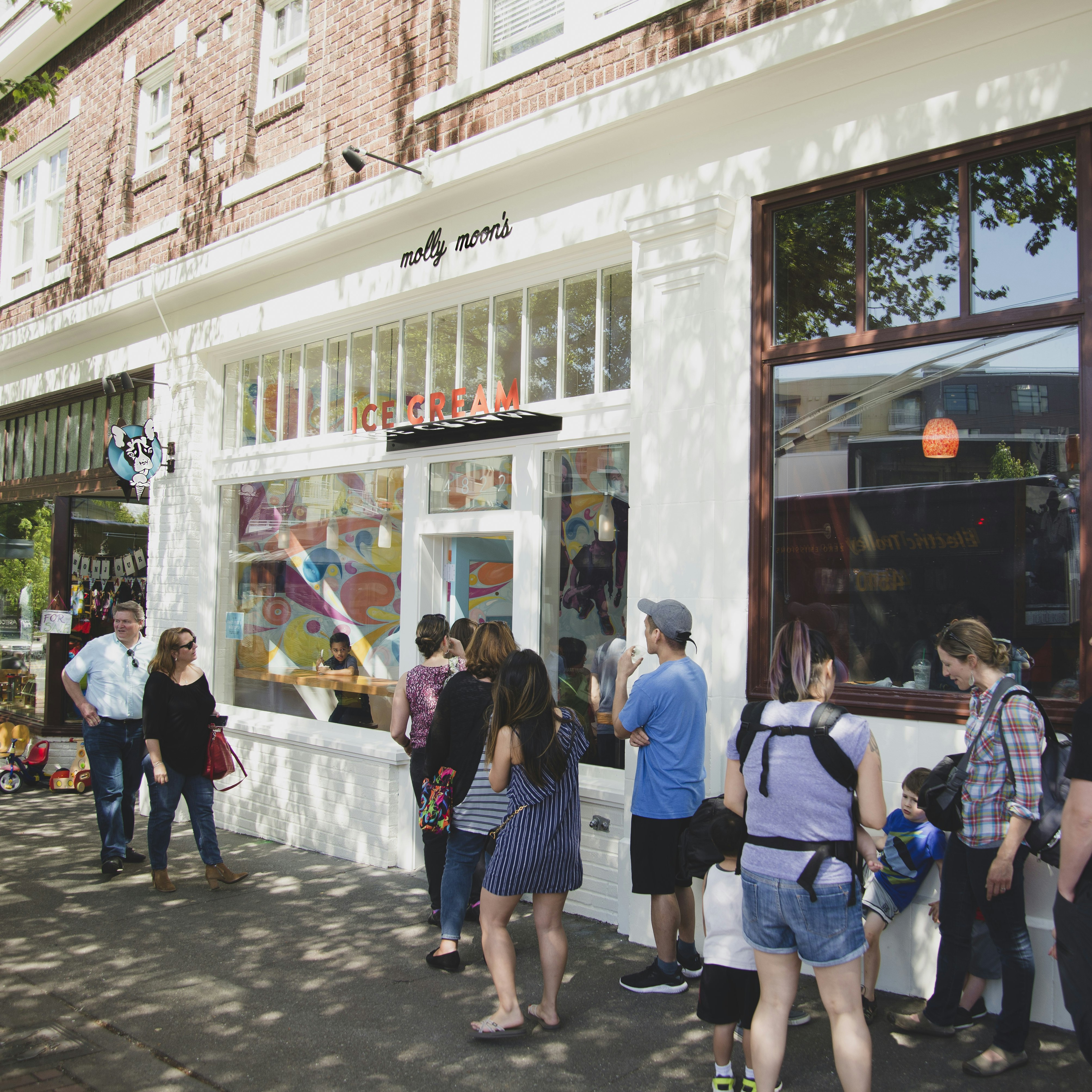 A group of people line up in front of Molly Moon's ice cream shop in Seattle
