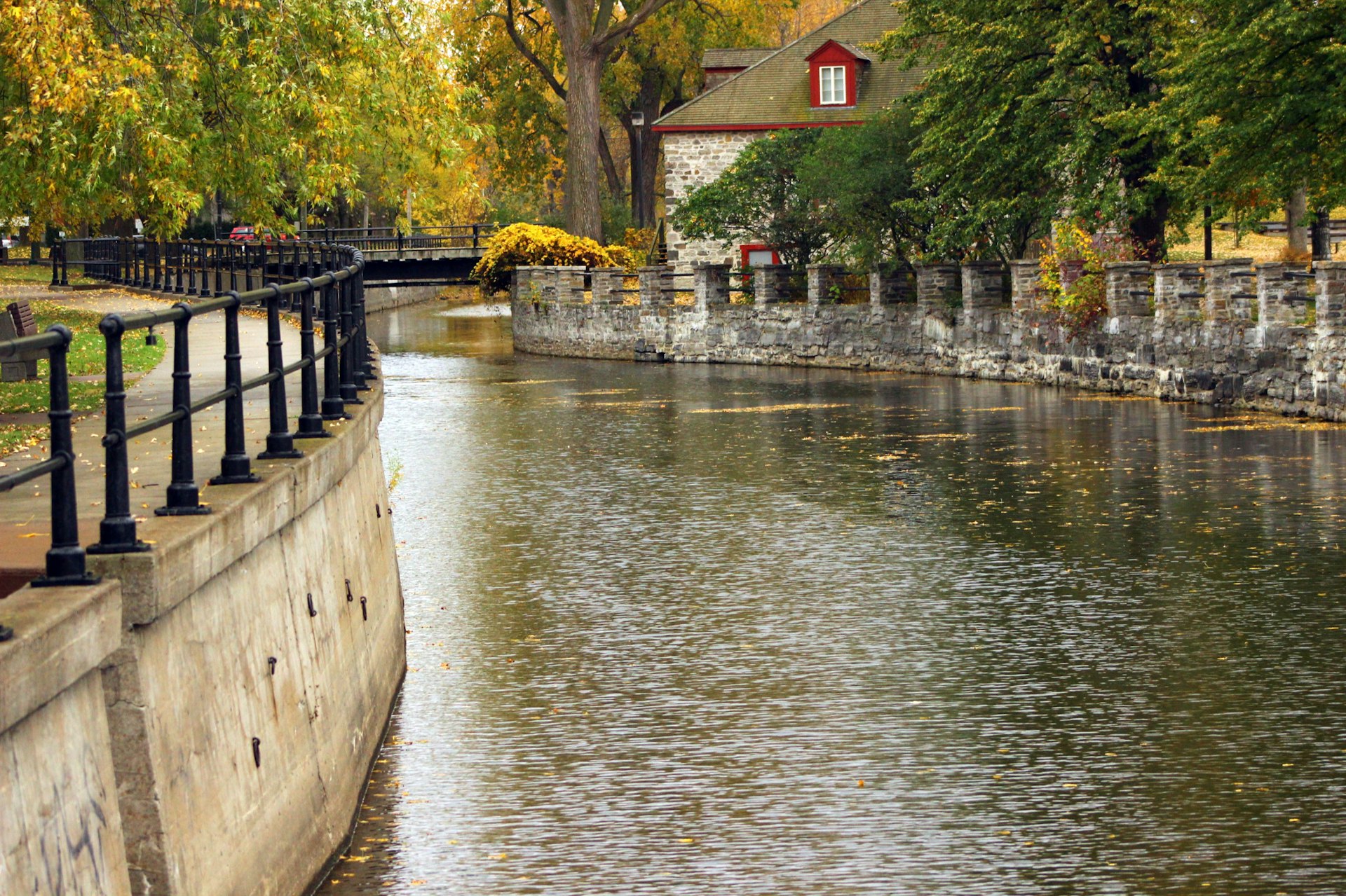 A curve in the Lachine Canal is highlighted with autumn leaves; Fall in Montreal