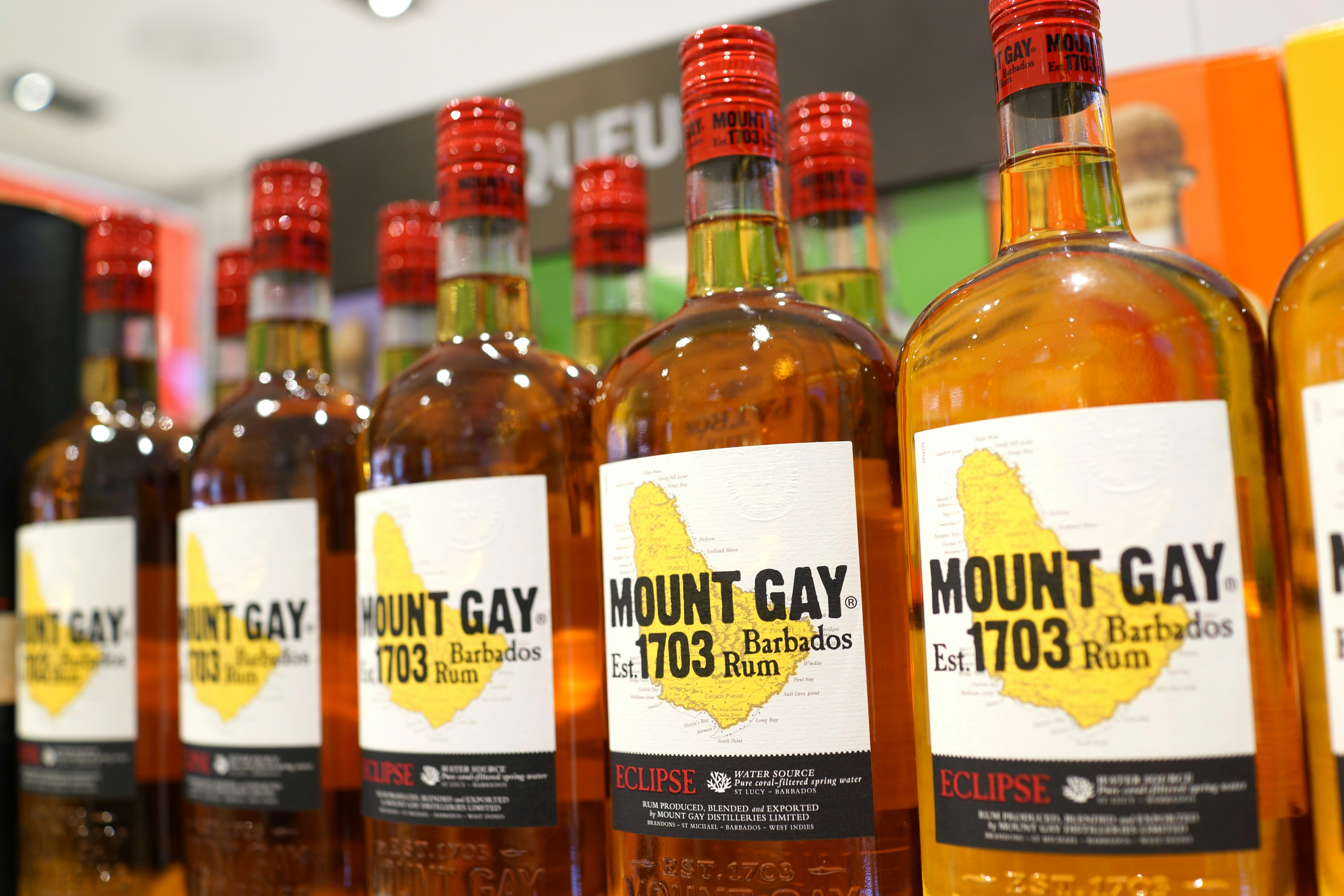 A row of Mount Gay bottles sit on a store cabinet; Barbados Rum Shops