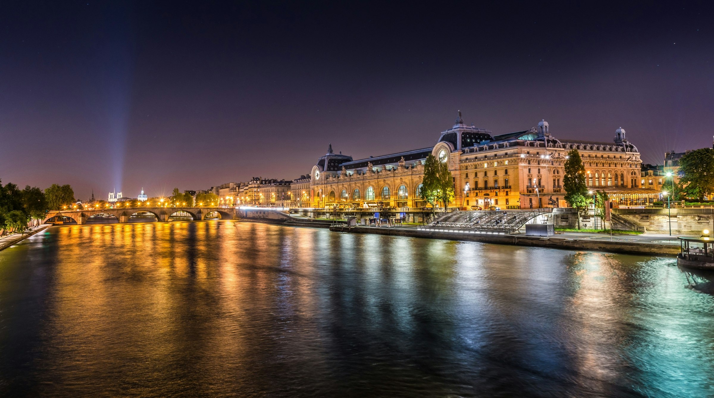 The d'Orsay Museum and the Seine river at night.