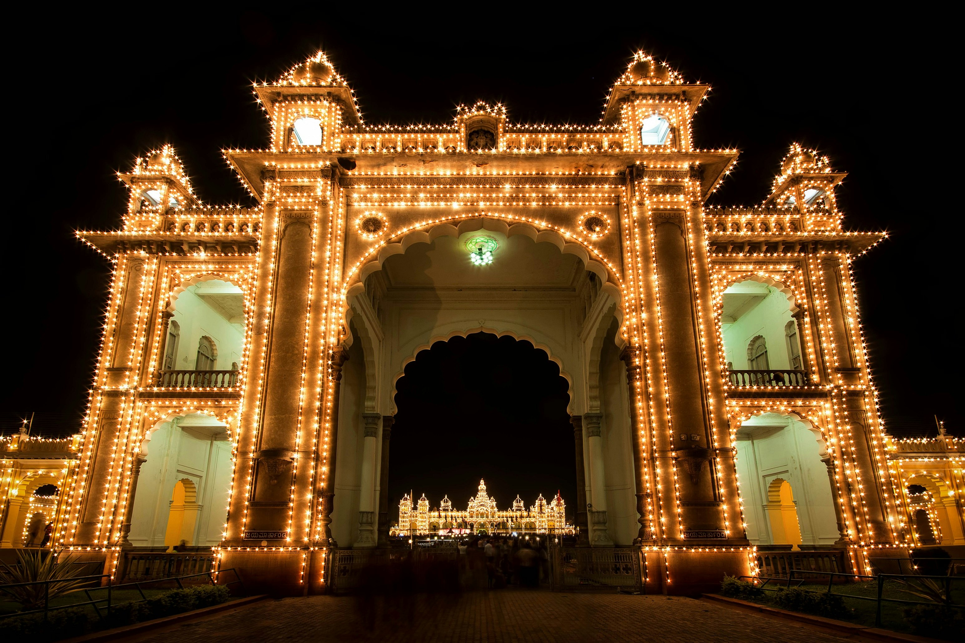 The grand Mysuru Palace, illuminated by thousands of light bulbs, glows in the darkness.