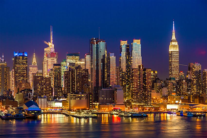 The midtown Manhattan skyline is illuminated at night.